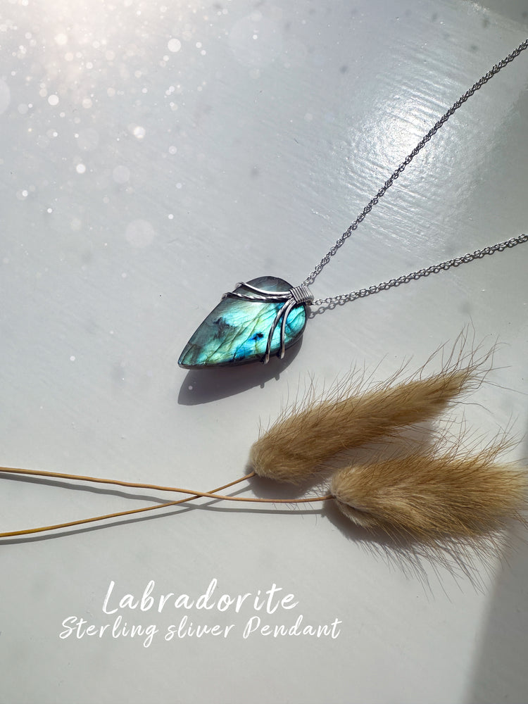 Beautifully wire wrapped labradorite natural crystal pendant. Wire wrapped in antiqued sterling silver wire.