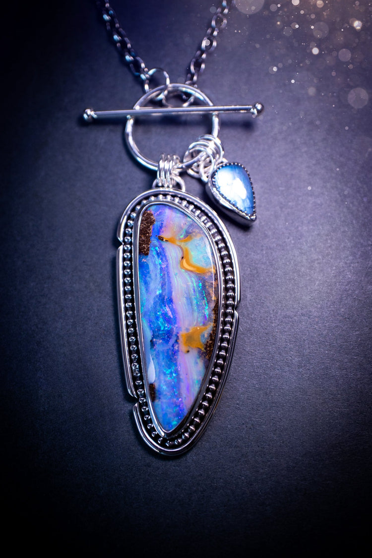 Beautiful and handcrafted, sterling silver amethyst and mother of pearl pendant necklace. Full of iridescent shine with a gorgeous purple hue. Complete with silver components and a little moon charm.