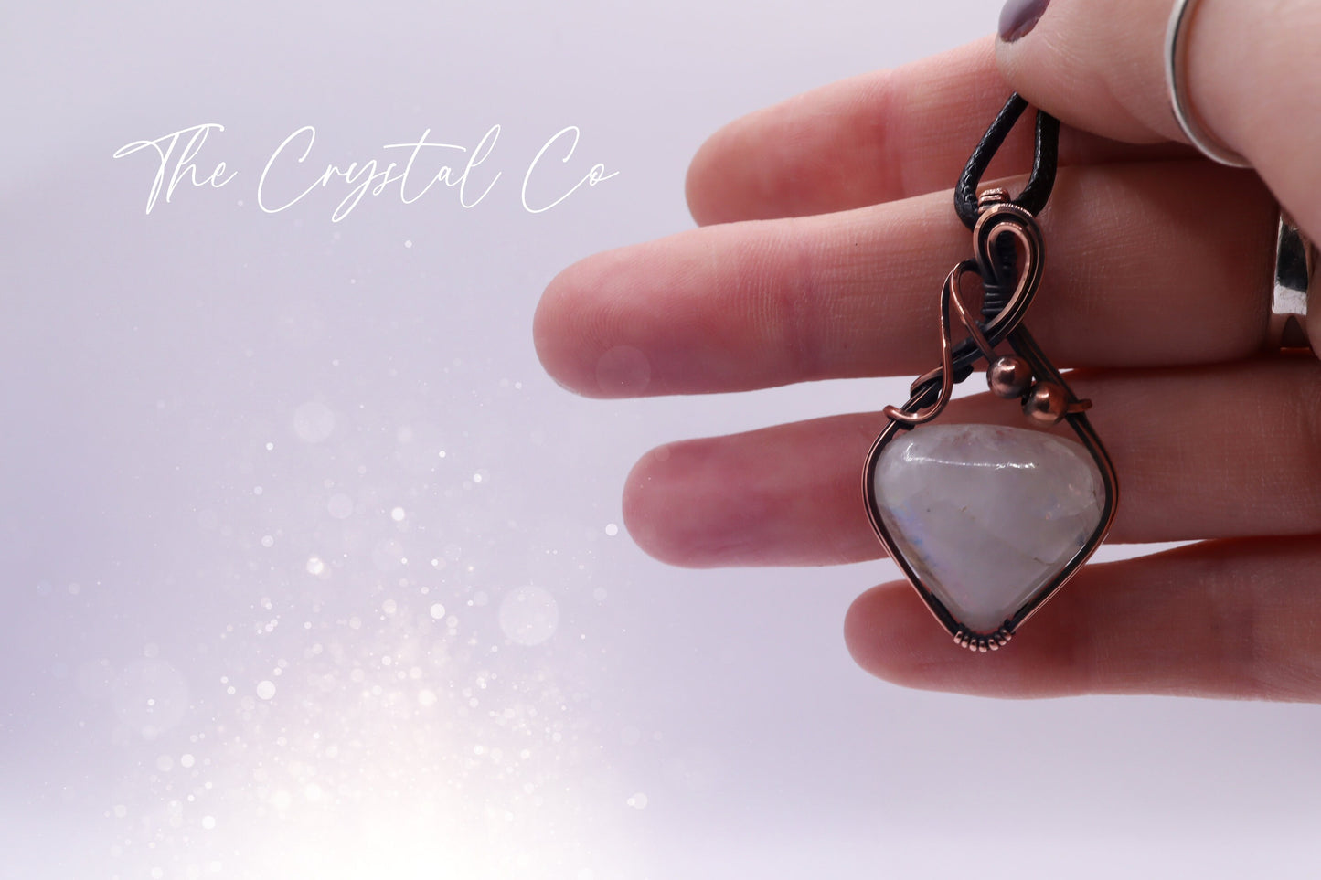 Beautiful flashy rainbow moonstone pendant, wire wrapped in antiqued copper wire Beautiful flashes of blue, greens and yellows Comes with a black cord chain. Ideal for individuals who love crystals and jewellery. Rainbow moonstone is also the birthstone for June making this an ideal gift for birthdays.