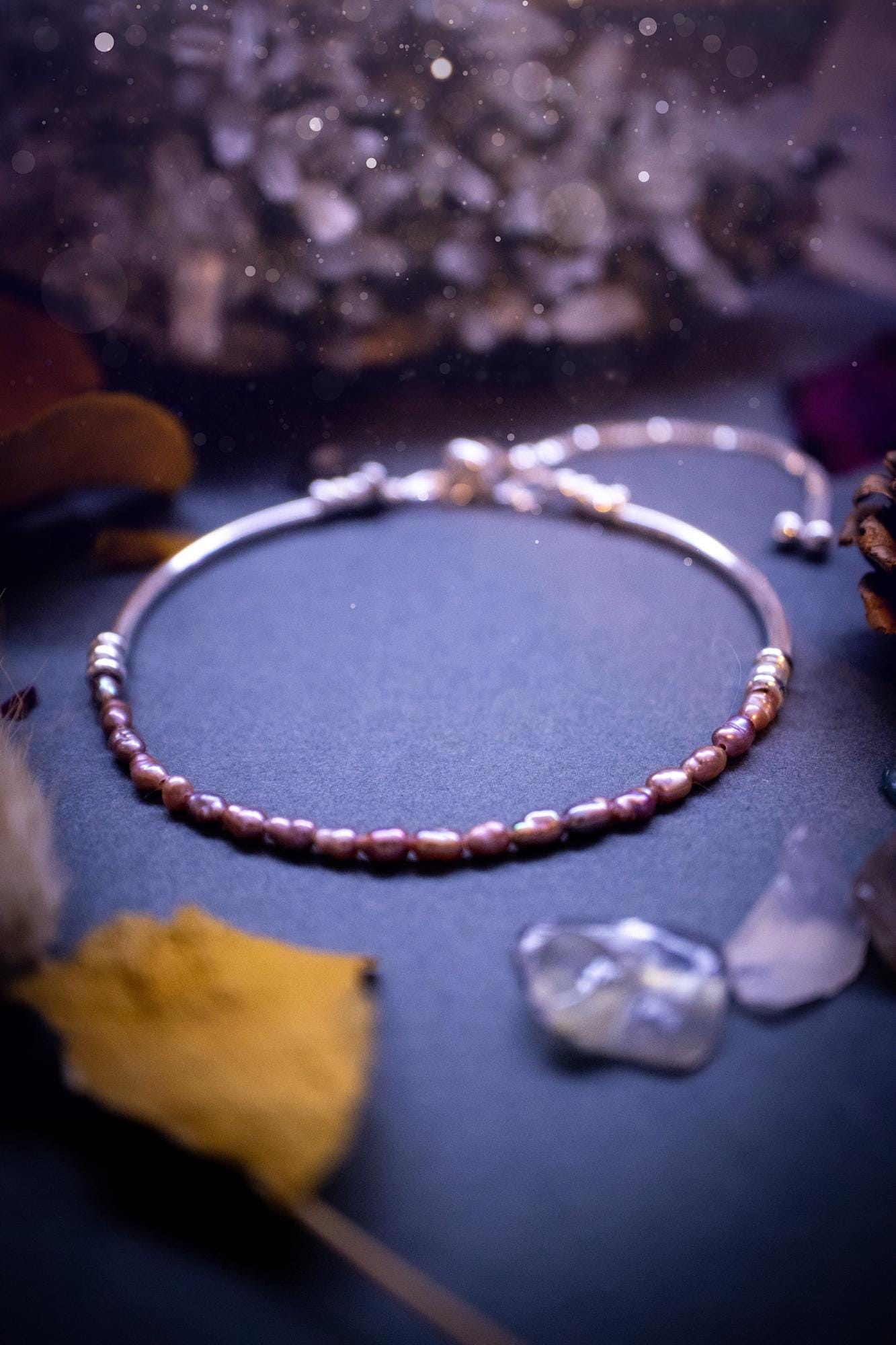 Beautifully handcrafted, pink mother of pearl, sterling silver, slider, stacker bracelet. This bracelet has high quality fresh water pearls that have been strung on 49 strand beading wire which is very strong yet gives a beautiful drape across the wrist. Featuring sterling silver spacer beads, a little moon charm and a bracelet slider as the clasp. This bracelet  would make the ideal gift for crystal lovers and would suit any outfit.