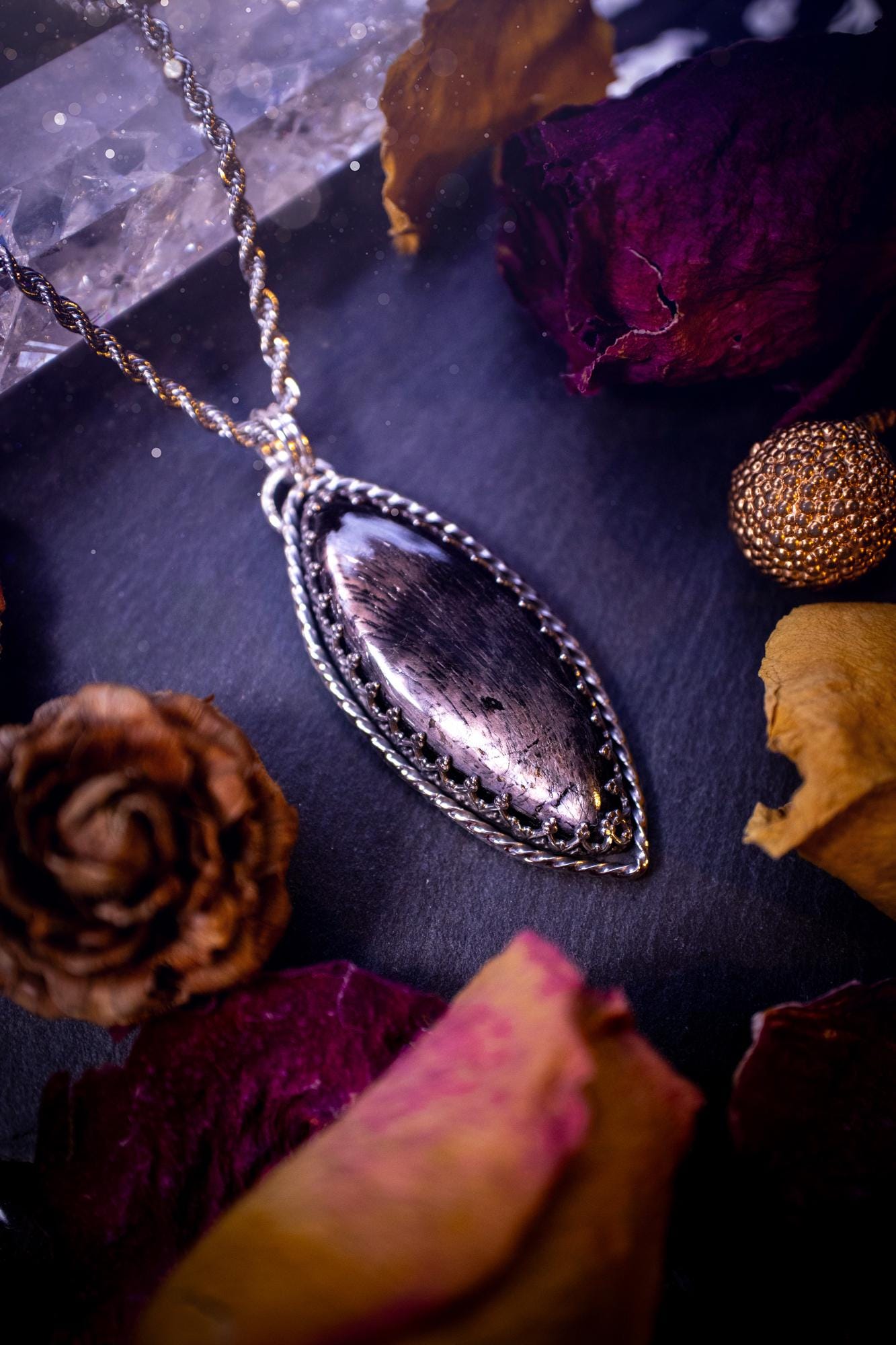 Beautifully handmade, and natural hypersthene crystal, sterling silver pendant necklace. This stunning pendant necklace features a marquise shaped hypersthene crystal gemstone that is full of shimmering silver flash. Rocking a minimalistic design with a gallery wire bezel to give off gothic and witchy vibes. This piece would be ideal as a gift for any jewellery and crystal lover, or even for yourself as a treat.