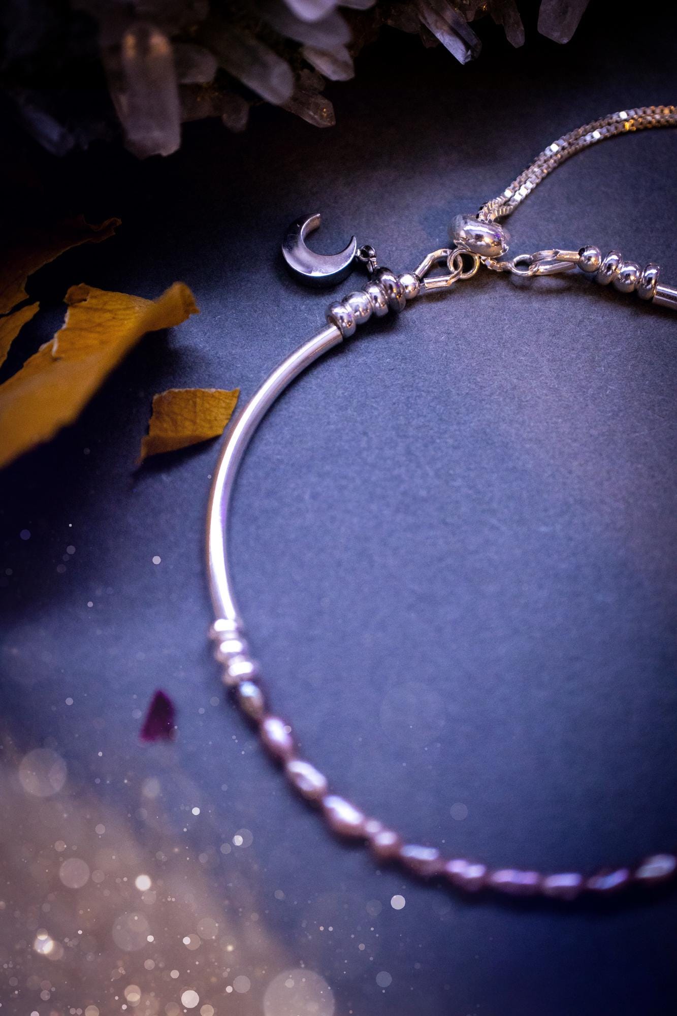 Beautifully handcrafted, pink mother of pearl, sterling silver, slider, stacker bracelet. This bracelet has high quality fresh water pearls that have been strung on 49 strand beading wire which is very strong yet gives a beautiful drape across the wrist. Featuring sterling silver spacer beads, a little moon charm and a bracelet slider as the clasp. This bracelet  would make the ideal gift for crystal lovers and would suit any outfit.