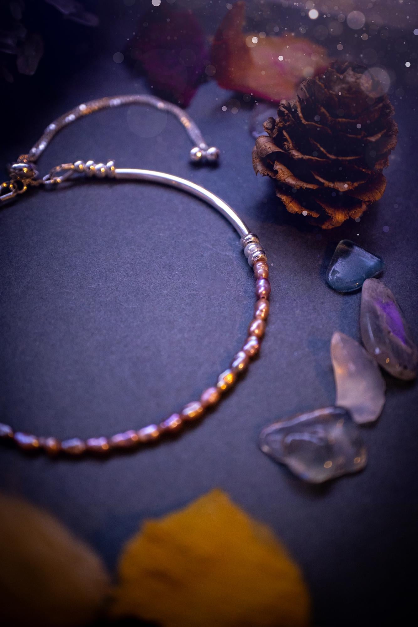 Beautifully handcrafted, pink mother of pearl, sterling silver, slider, stacker bracelet. This bracelet has high quality fresh water pearls that have been strung on 49 strand beading wire which is very strong yet gives a beautiful drape across the wrist. Featuring sterling silver spacer beads, a little moon charm and a bracelet slider as the clasp. This bracelet  would make the ideal gift for crystal lovers and would suit any outfit.