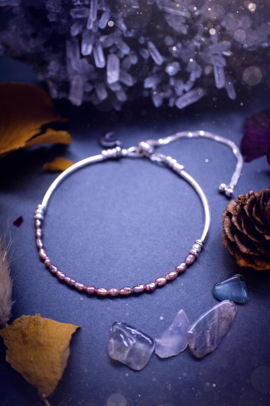 Beautifully handcrafted, pink mother of pearl, sterling silver, slider, stacker bracelet. This bracelet has high quality fresh water pearls that have been strung on 49 strand beading wire which is very strong yet gives a beautiful drape across the wrist. Featuring sterling silver spacer beads, a little moon charm and a bracelet slider as the clasp. This bracelet  would make the ideal gift for crystal lovers and would suit any outfit.