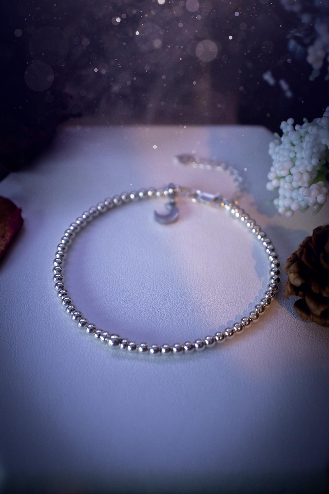 Beautiful and handmade, 3mm beaded, sterling silver stacking bracelet. This bracelet has been made using high quality sterling silver beads which have bee strung on strong 49 strand beading wire. This wire is very strong, but also gives a beautiful drape across the wrist. Featuring one larger silver spacer bead in the middle with rondelle beads either side to give some uniqueness. This bracelet is ideal for stacking with others, and makes a lovely gift for jewellery lovers.