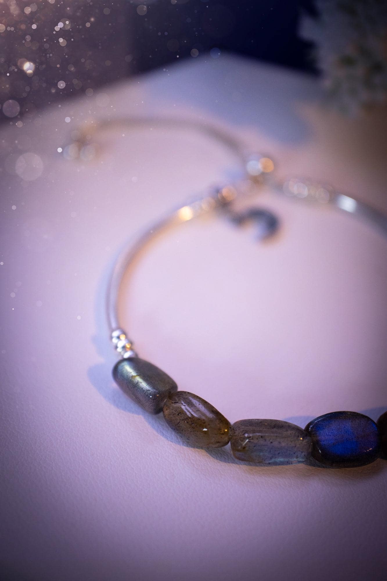 Beautiful and handmade, Labradorite crystal nugget, sterling silver stacking bracelet. This bracelet has been made using high quality sterling silver beads which have bee strung on strong 49 strand beading wire. This wire is very strong, but also gives a beautiful drape across the wrist. Featuring beautiful and flashy labradorite crystal nugget beads. This bracelet is ideal for stacking with others, and makes a lovely gift for jewellery lovers.