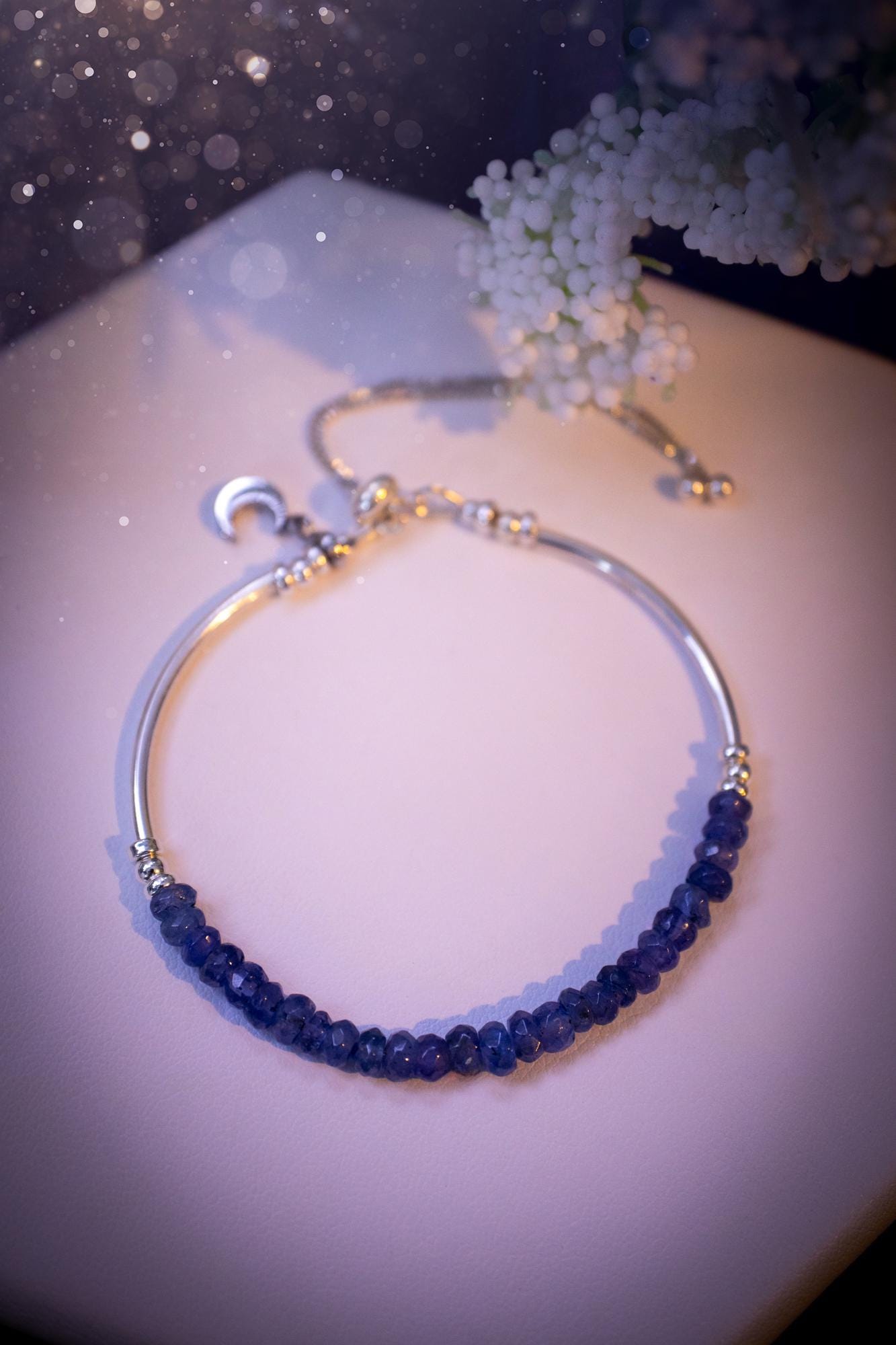 Beautiful and handmade, Tanzanite crystal nugget, sterling silver stacking bracelet. This bracelet has been made using high quality sterling silver beads which have bee strung on strong 49 strand beading wire. This wire is very strong, but also gives a beautiful drape across the wrist. Featuring beautiful and flashy tanzanite crystal nugget beads. This bracelet is ideal for stacking with others, and makes a lovely gift for jewellery lovers.
