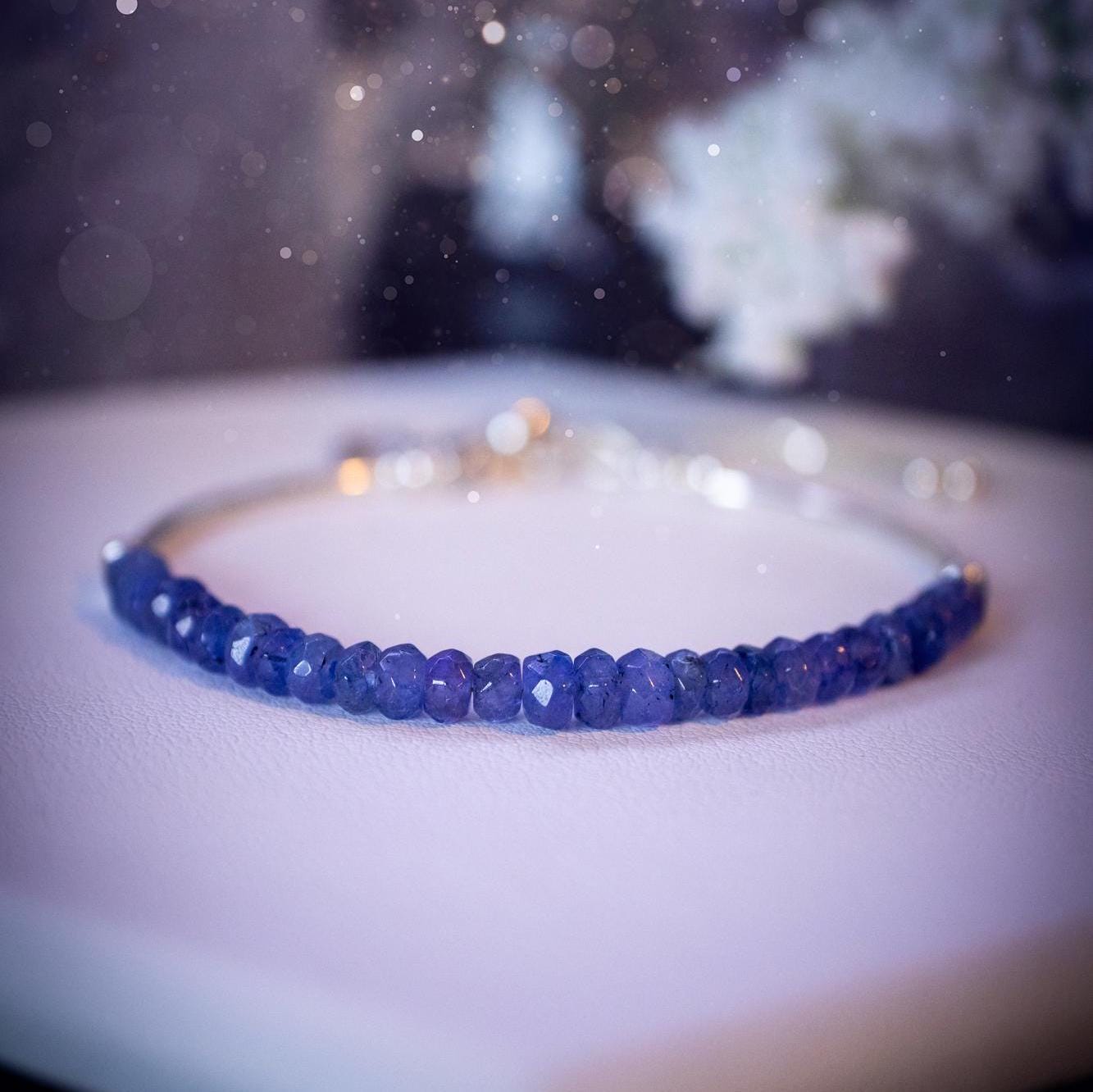 Beautiful and handmade, Tanzanite crystal nugget, sterling silver stacking bracelet. This bracelet has been made using high quality sterling silver beads which have bee strung on strong 49 strand beading wire. This wire is very strong, but also gives a beautiful drape across the wrist. Featuring beautiful and flashy tanzanite crystal nugget beads. This bracelet is ideal for stacking with others, and makes a lovely gift for jewellery lovers.