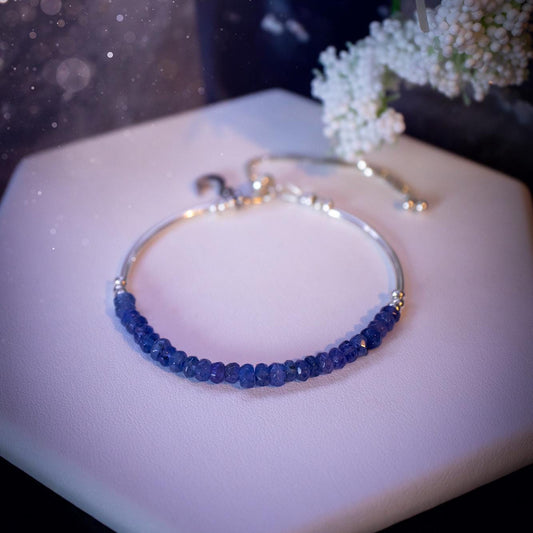 Beautiful and handmade, Tanzanite crystal nugget, sterling silver stacking bracelet. This bracelet has been made using high quality sterling silver beads which have bee strung on strong 49 strand beading wire. This wire is very strong, but also gives a beautiful drape across the wrist. Featuring beautiful and flashy tanzanite crystal nugget beads. This bracelet is ideal for stacking with others, and makes a lovely gift for jewellery lovers.
