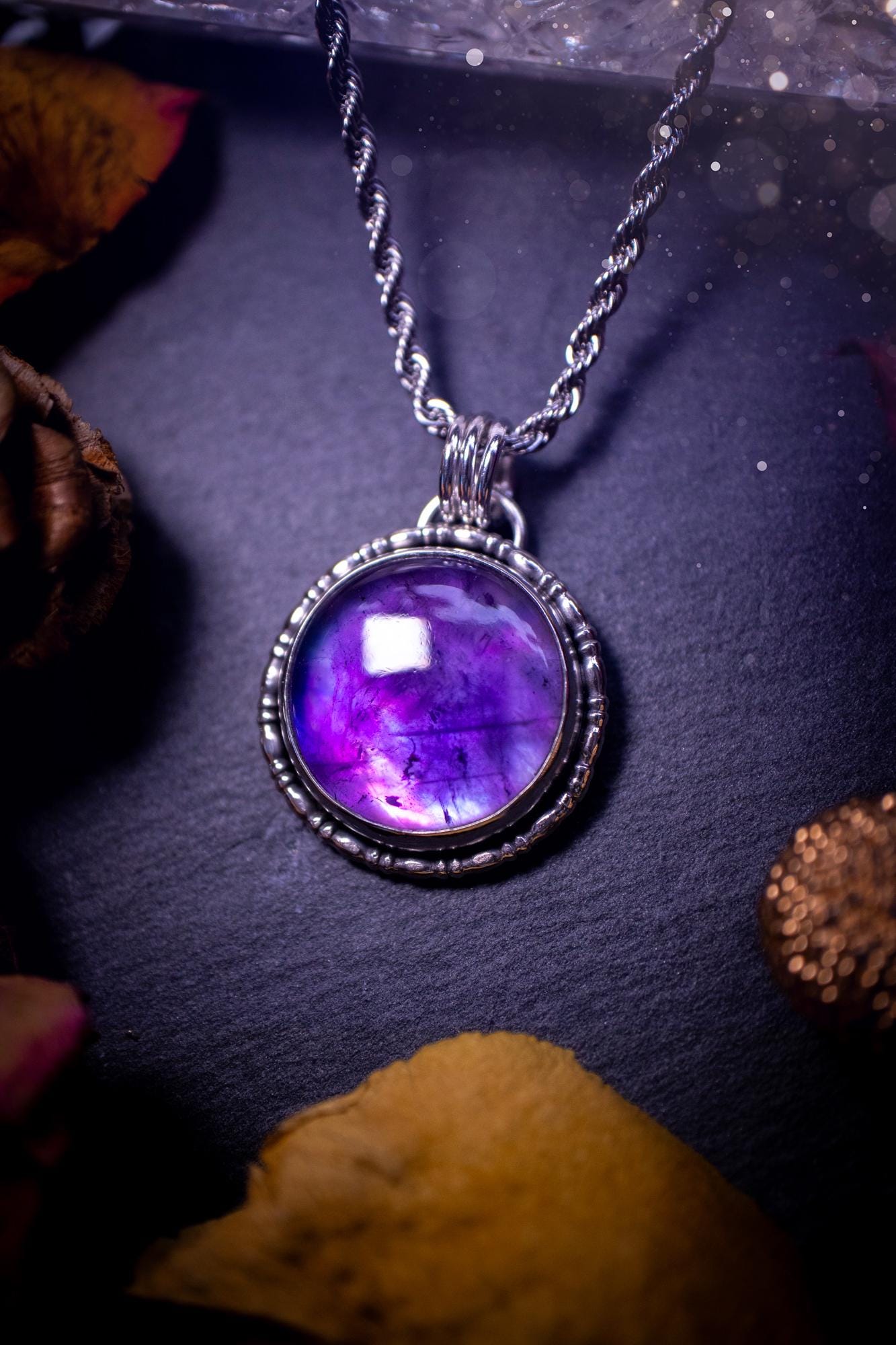 Beautifully handmade, and a one of a kind piece, mother of pearl and amethyst doublet, sterling silver pendant necklace. This pendant features the most beautiful MOP and amethyst doublet that is full of dreamy rainbows with a stunning purple hue. The pendant has been crafted using recycled fine and sterling silver, with a minimalistic design and fancy gallery wire around the circular bezel. This piece is ideal for crystal and jewellery lovers, giving hippy and mermaid vibes.