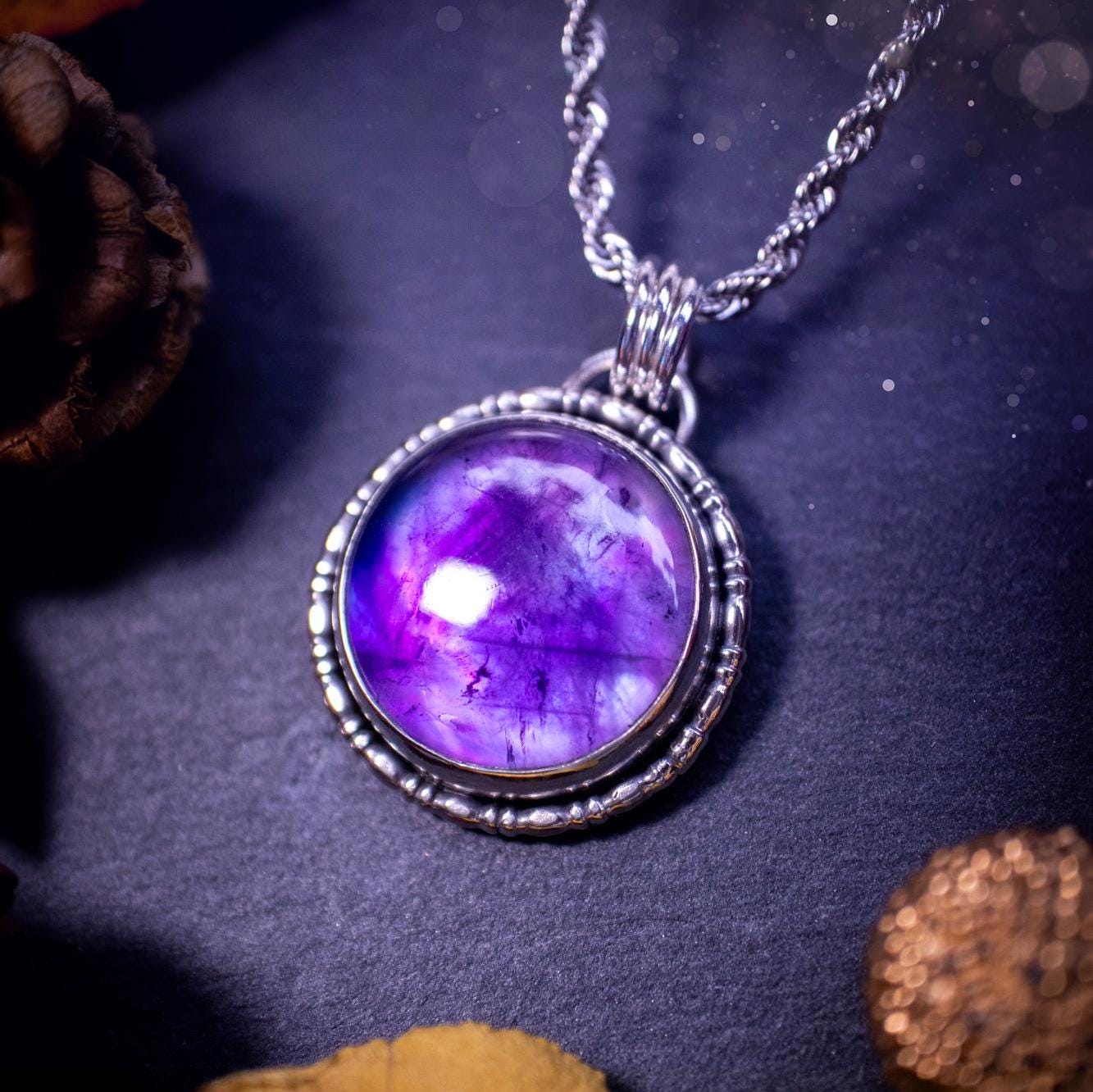 Beautifully handmade, and a one of a kind piece, mother of pearl and amethyst doublet, sterling silver pendant necklace. This pendant features the most beautiful MOP and amethyst doublet that is full of dreamy rainbows with a stunning purple hue. The pendant has been crafted using recycled fine and sterling silver, with a minimalistic design and fancy gallery wire around the circular bezel. This piece is ideal for crystal and jewellery lovers, giving hippy and mermaid vibes.