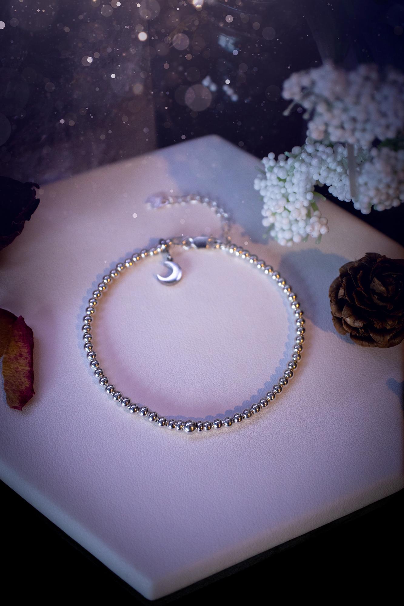 Beautiful and handmade, 3mm beaded, sterling silver stacking bracelet. This bracelet has been made using high quality sterling silver beads which have bee strung on strong 49 strand beading wire. This wire is very strong, but also gives a beautiful drape across the wrist. Featuring one larger silver spacer bead in the middle with rondelle beads either side to give some uniqueness. This bracelet is ideal for stacking with others, and makes a lovely gift for jewellery lovers.