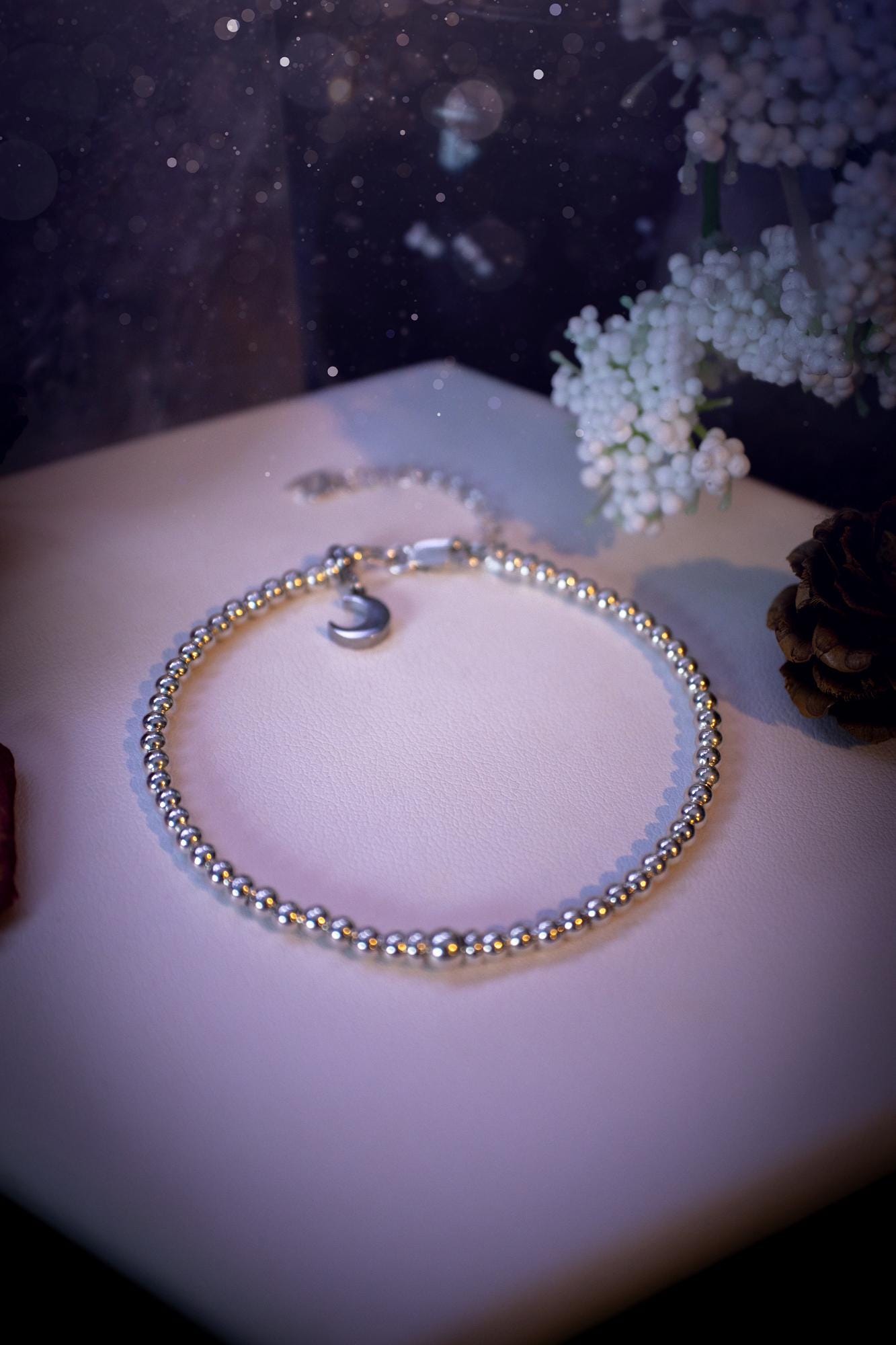 Beautiful and handmade, 3mm beaded, sterling silver stacking bracelet. This bracelet has been made using high quality sterling silver beads which have bee strung on strong 49 strand beading wire. This wire is very strong, but also gives a beautiful drape across the wrist. Featuring one larger silver spacer bead in the middle with rondelle beads either side to give some uniqueness. This bracelet is ideal for stacking with others, and makes a lovely gift for jewellery lovers.