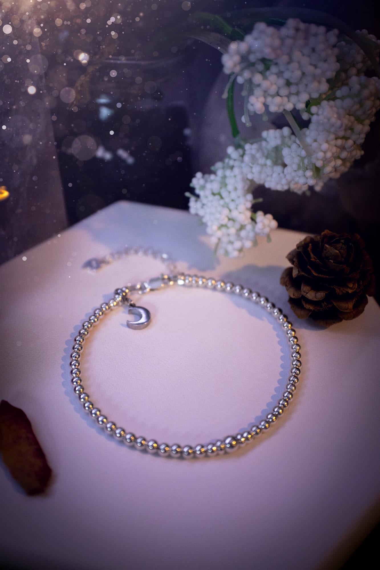 Beautiful and handmade, 3mm beaded, sterling silver stacking bracelet. This bracelet has been made using high quality sterling silver beads which have bee strung on strong 49 strand beading wire. This wire is very strong, but also gives a beautiful drape across the wrist. Featuring one larger silver spacer bead in the middle with rondelle beads either side to give some uniqueness. This bracelet is ideal for stacking with others, and makes a lovely gift for jewellery lovers.