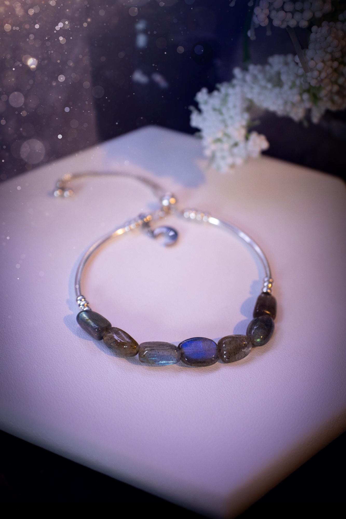 Beautiful and handmade, Labradorite crystal nugget, sterling silver stacking bracelet. This bracelet has been made using high quality sterling silver beads which have bee strung on strong 49 strand beading wire. This wire is very strong, but also gives a beautiful drape across the wrist. Featuring beautiful and flashy labradorite crystal nugget beads. This bracelet is ideal for stacking with others, and makes a lovely gift for jewellery lovers.