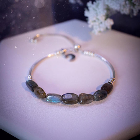 Beautiful and handmade, Labradorite crystal nugget, sterling silver stacking bracelet. This bracelet has been made using high quality sterling silver beads which have bee strung on strong 49 strand beading wire. This wire is very strong, but also gives a beautiful drape across the wrist. Featuring beautiful and flashy labradorite crystal nugget beads. This bracelet is ideal for stacking with others, and makes a lovely gift for jewellery lovers.