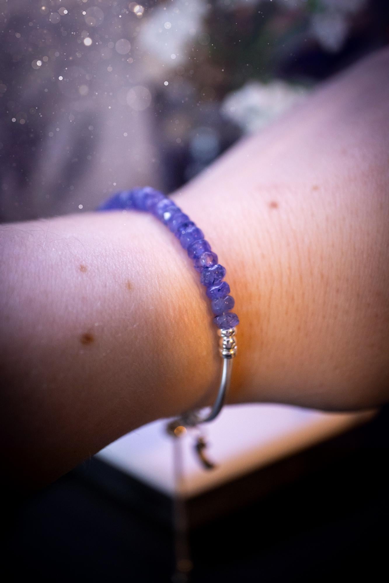 Beautiful and handmade, Tanzanite crystal nugget, sterling silver stacking bracelet. This bracelet has been made using high quality sterling silver beads which have bee strung on strong 49 strand beading wire. This wire is very strong, but also gives a beautiful drape across the wrist. Featuring beautiful and flashy tanzanite crystal nugget beads. This bracelet is ideal for stacking with others, and makes a lovely gift for jewellery lovers.