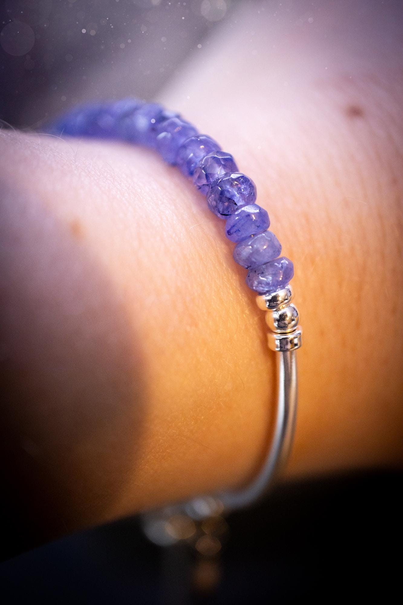 Beautiful and handmade, Tanzanite crystal nugget, sterling silver stacking bracelet. This bracelet has been made using high quality sterling silver beads which have bee strung on strong 49 strand beading wire. This wire is very strong, but also gives a beautiful drape across the wrist. Featuring beautiful and flashy tanzanite crystal nugget beads. This bracelet is ideal for stacking with others, and makes a lovely gift for jewellery lovers.