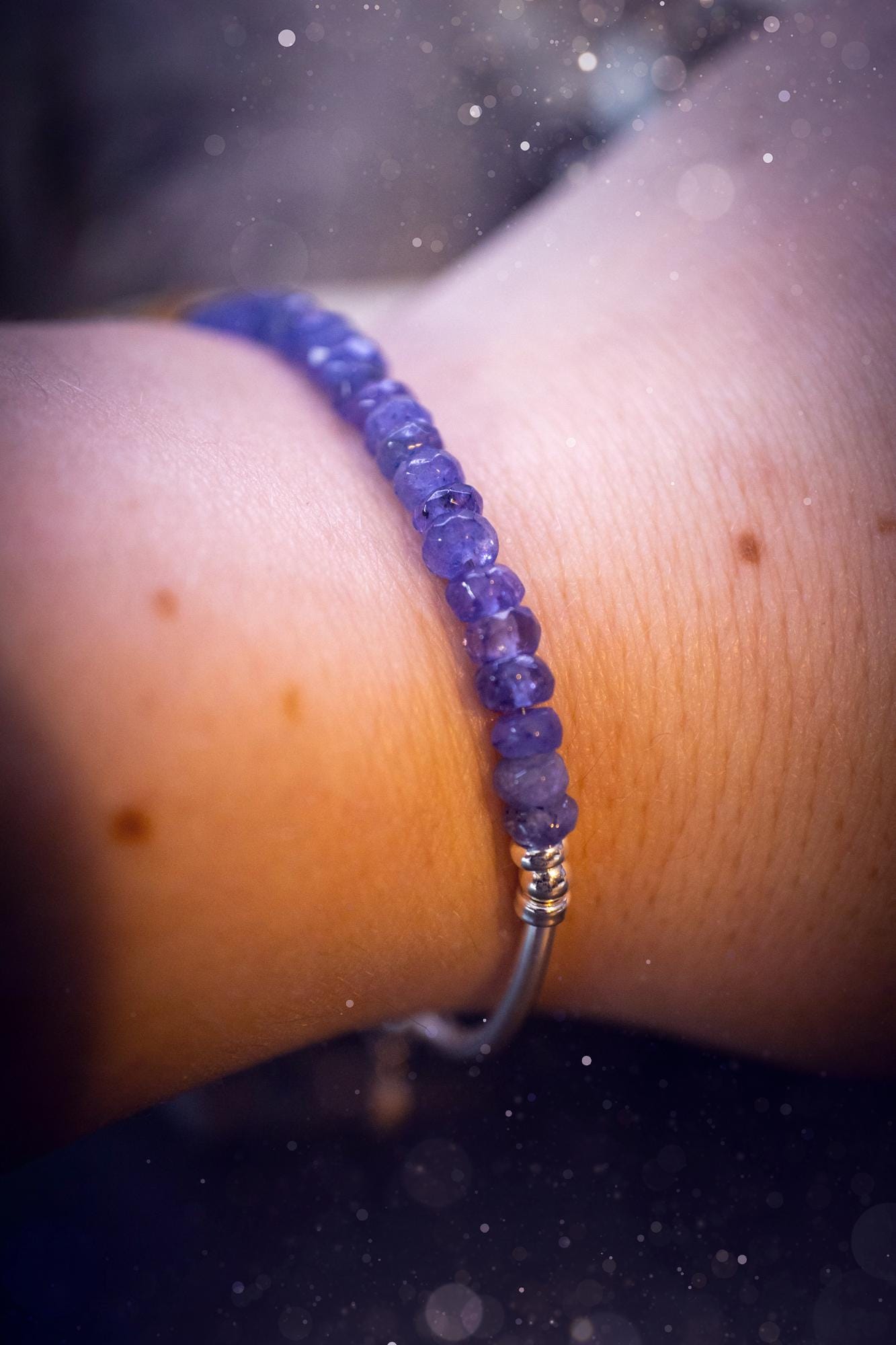 Beautiful and handmade, Tanzanite crystal nugget, sterling silver stacking bracelet. This bracelet has been made using high quality sterling silver beads which have bee strung on strong 49 strand beading wire. This wire is very strong, but also gives a beautiful drape across the wrist. Featuring beautiful and flashy tanzanite crystal nugget beads. This bracelet is ideal for stacking with others, and makes a lovely gift for jewellery lovers.