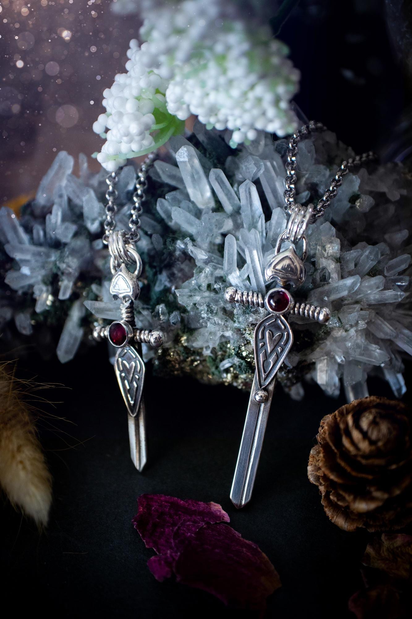 Handmade sterling silver pendant necklace in the shape of a sword, featuring a beautiful garnet as the centre piece. This piece of jewellery has been created using recycled fine and sterling silver and features a gorgeous garnet that is full of sparkle. Suitable or special occasions such as birthdays, anniversaries, graduations and more. Garnet is the birthstone for January. Witchy and gothic handmade jewellery, medieval.