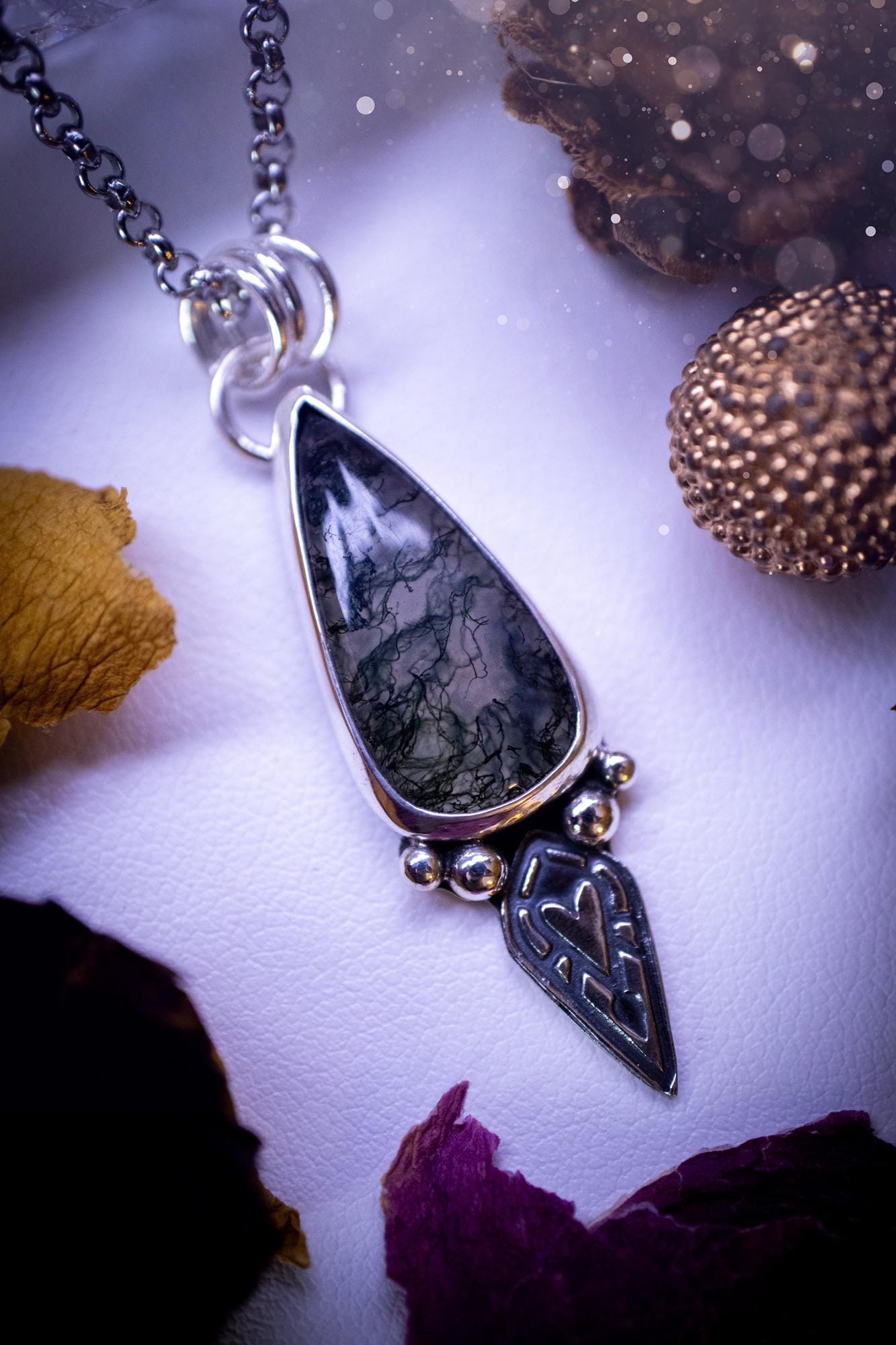 Handmade and one of a kind, 'heart of the wild' Moss agate crystal pendant necklace. This pendant necklace has been design and handmade from scratch, made from recycled fine and sterling silver. Featuring the moss beautiful and natural Moss agate crystal, with an open back on the pendant so you can see through the stone revealing all the beautiful mossy patterns. On the pendant is sterling silver ball components with a heart of the wild stamp, ideal gift for her, witchy and gothic jewell
