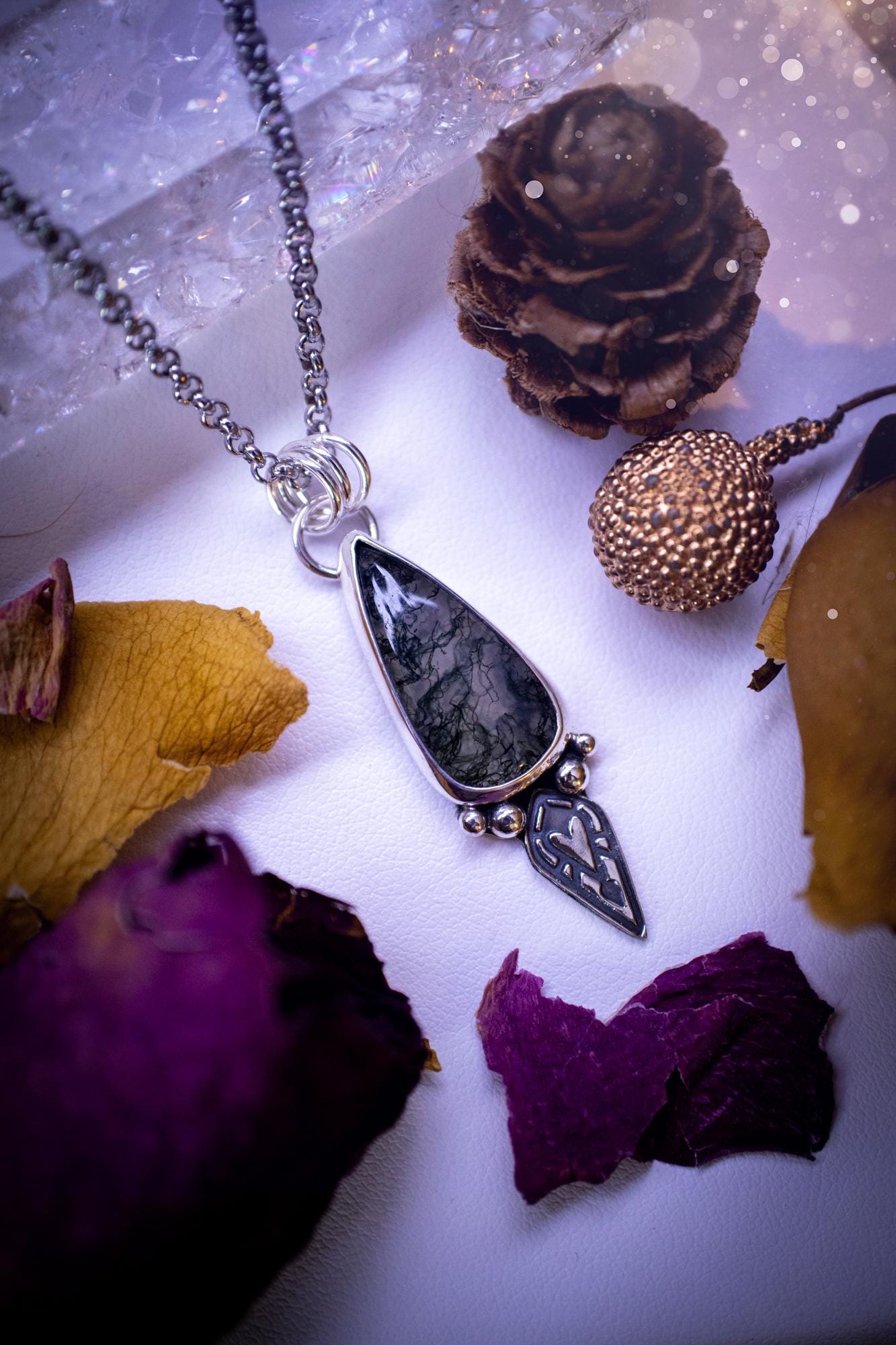 Handmade and one of a kind, 'heart of the wild' Moss agate crystal pendant necklace. This pendant necklace has been design and handmade from scratch, made from recycled fine and sterling silver. Featuring the moss beautiful and natural Moss agate crystal, with an open back on the pendant so you can see through the stone revealing all the beautiful mossy patterns. On the pendant is sterling silver ball components with a heart of the wild stamp, ideal gift for her, witchy and gothic jewell