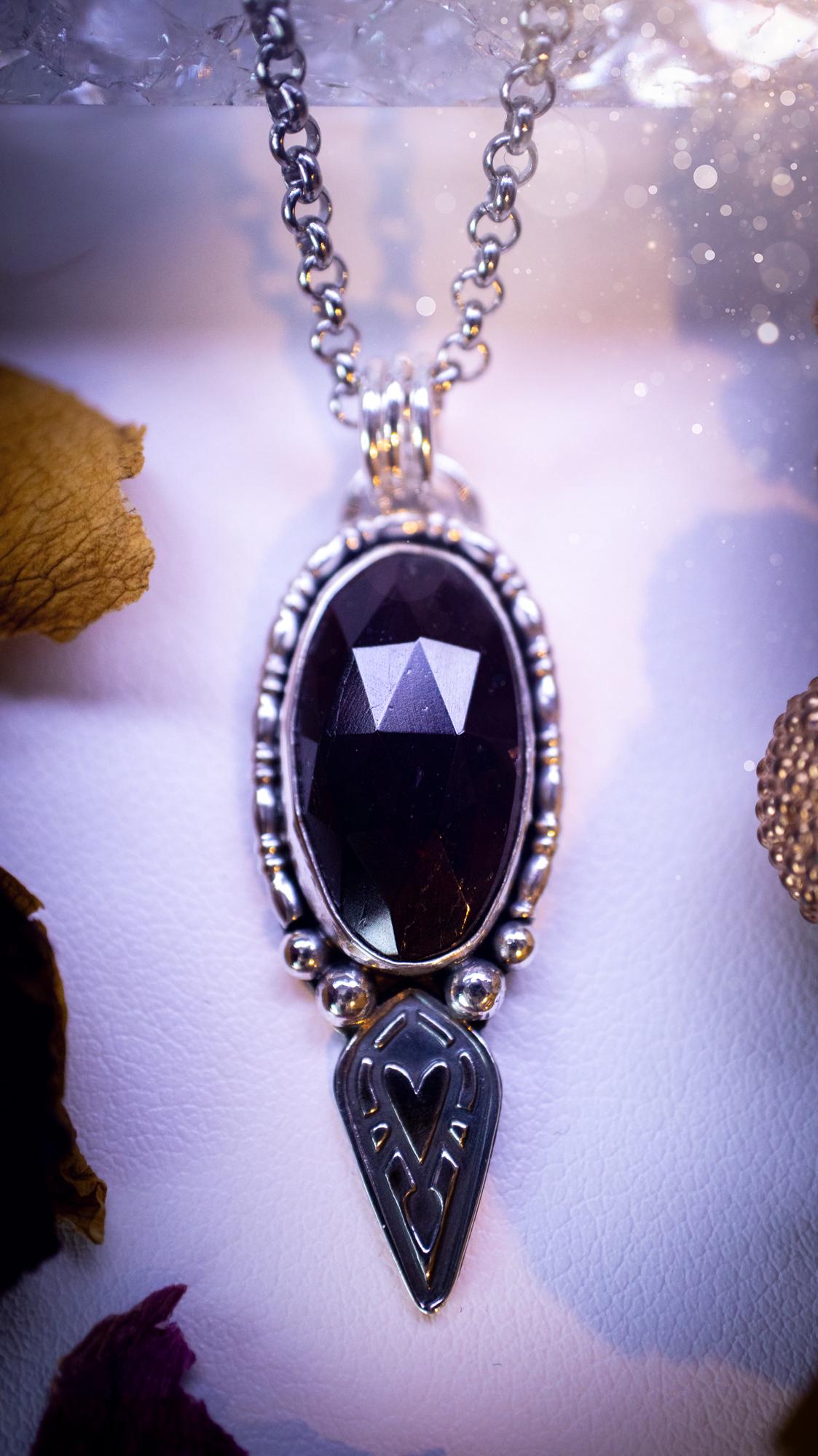 Handmade and one of a kind, 'heart of the wild' garnet crystal pendant necklace. This pendant necklace has been design and handmade from scratch, made from recycled fine and sterling silver. Featuring the most beautiful and natural garnet crystal, the crystal is a deep dark red with pink hues, but can look nearly black from some angles. On the pendant is sterling silver ball components with a heart of the wild stamp, ideal gift for her, witchy and gothic jewellery.