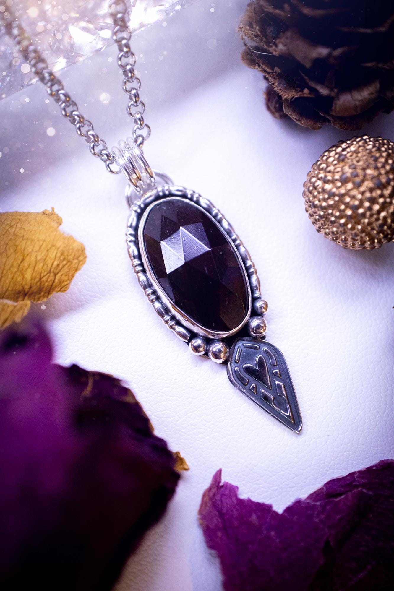 Handmade and one of a kind, 'heart of the wild' garnet crystal pendant necklace. This pendant necklace has been design and handmade from scratch, made from recycled fine and sterling silver. Featuring the most beautiful and natural garnet crystal, the crystal is a deep dark red with pink hues, but can look nearly black from some angles. On the pendant is sterling silver ball components with a heart of the wild stamp, ideal gift for her, witchy and gothic jewellery.