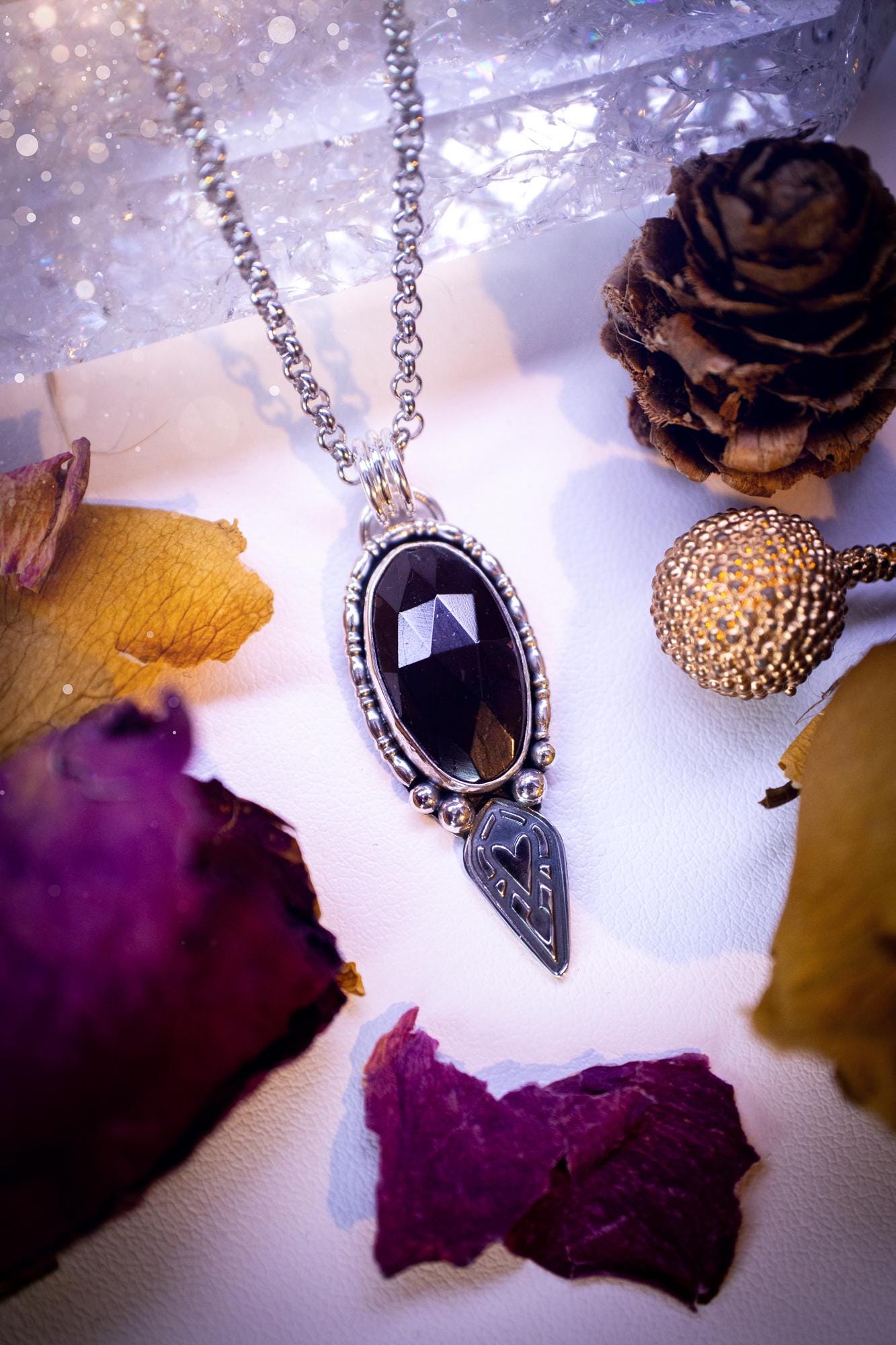 Handmade and one of a kind, 'heart of the wild' garnet crystal pendant necklace. This pendant necklace has been design and handmade from scratch, made from recycled fine and sterling silver. Featuring the most beautiful and natural garnet crystal, the crystal is a deep dark red with pink hues, but can look nearly black from some angles. On the pendant is sterling silver ball components with a heart of the wild stamp, ideal gift for her, witchy and gothic jewellery.