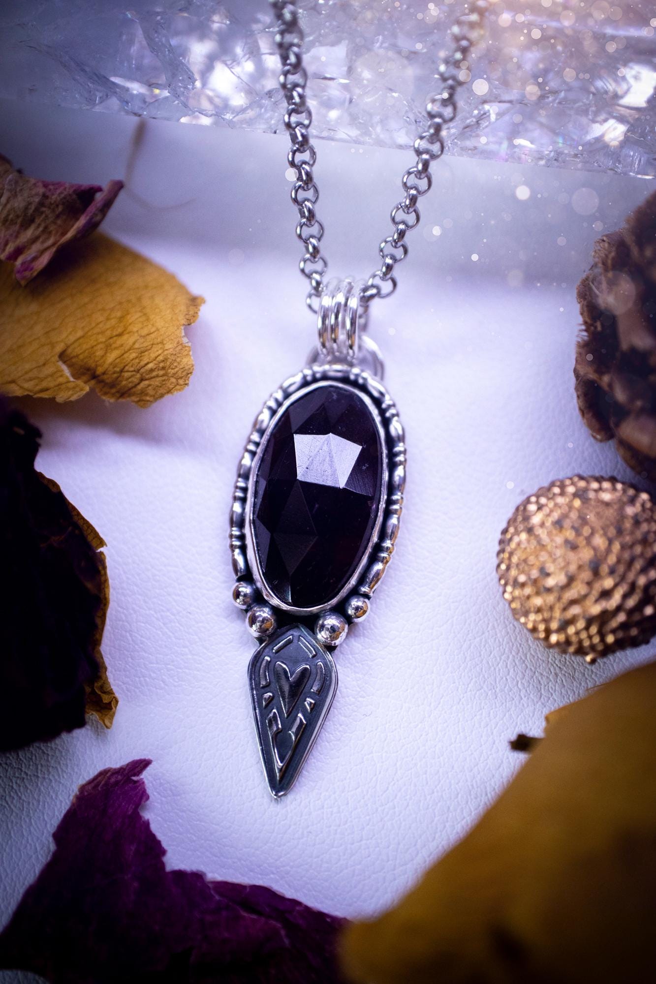 Handmade and one of a kind, 'heart of the wild' garnet crystal pendant necklace. This pendant necklace has been design and handmade from scratch, made from recycled fine and sterling silver. Featuring the most beautiful and natural garnet crystal, the crystal is a deep dark red with pink hues, but can look nearly black from some angles. On the pendant is sterling silver ball components with a heart of the wild stamp, ideal gift for her, witchy and gothic jewellery.