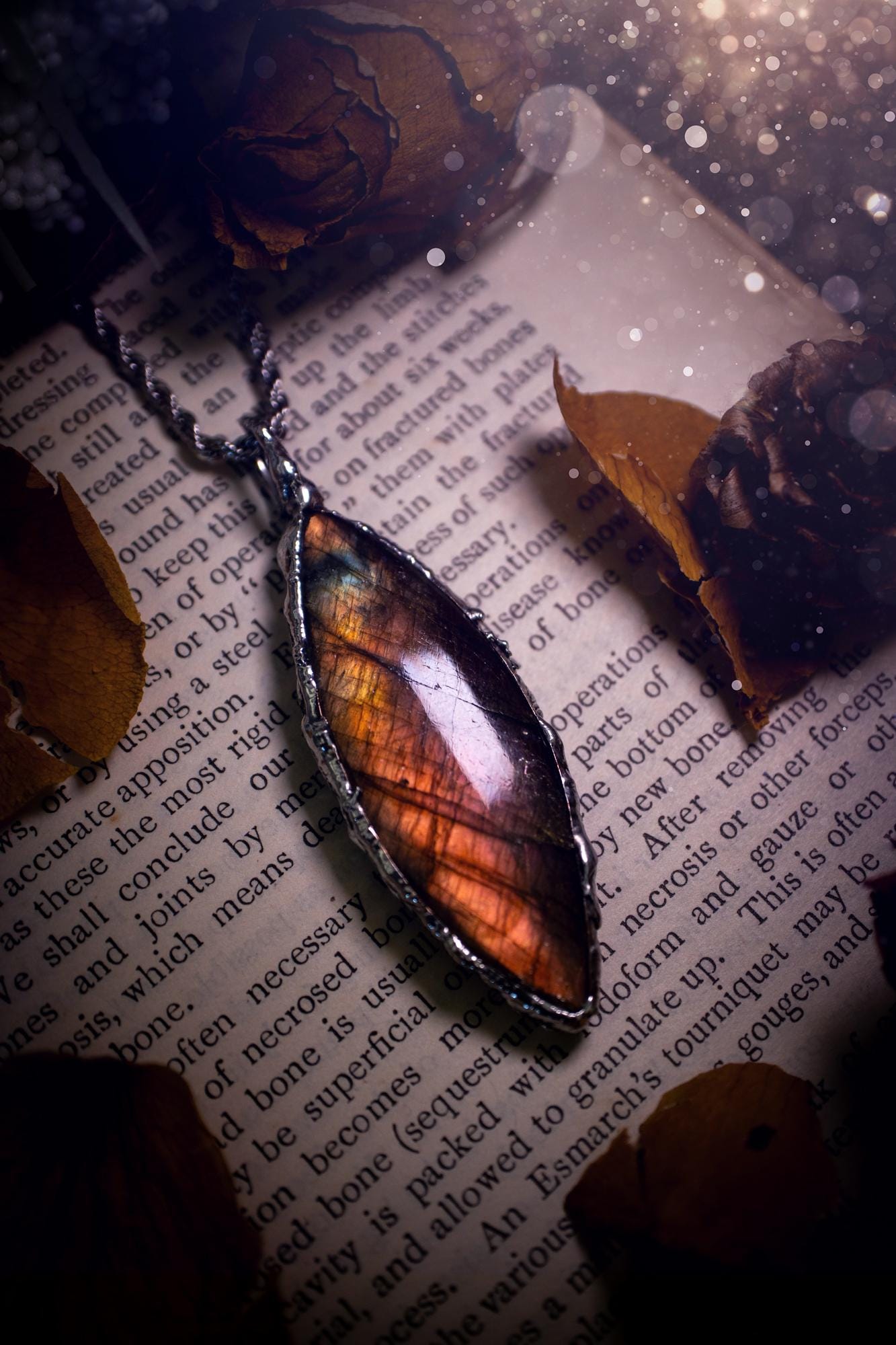 A beautiful, one of a kind, pink, purple and orange multi-flash Labradorite crystal pendant necklace. This pendant has been handmade using the soft solder method, also known as the tiffany technique used to create stained glass windows. Featuring the most stunning and natural Labradorite crystal which is full of purple and pink hues. The pendant is suitable for gifting to any jewellery or crystal lover, or to simply add to your own collection. One of a kind jewellery, gothic and witchy gifts