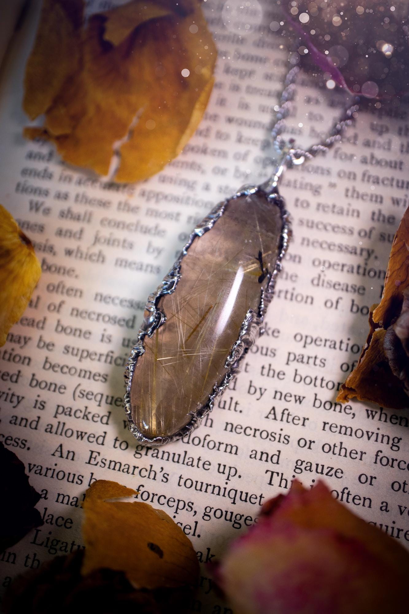 Handcrafted and unique, golden rutile quartz crystal, soft soldered pendant necklace. This pendant necklace has been handcrafted using the soft soldering method, also known as the tiffany technique. This method uses lead free solder which contains elements of silver for a high polish. This pendant features the most gorgeous and high quality, gold rutile quartz full of golden stripes with high clarity. Ideal gift for crystal and jewellery lovers. Witchy and gothic jewellery gifts for her.