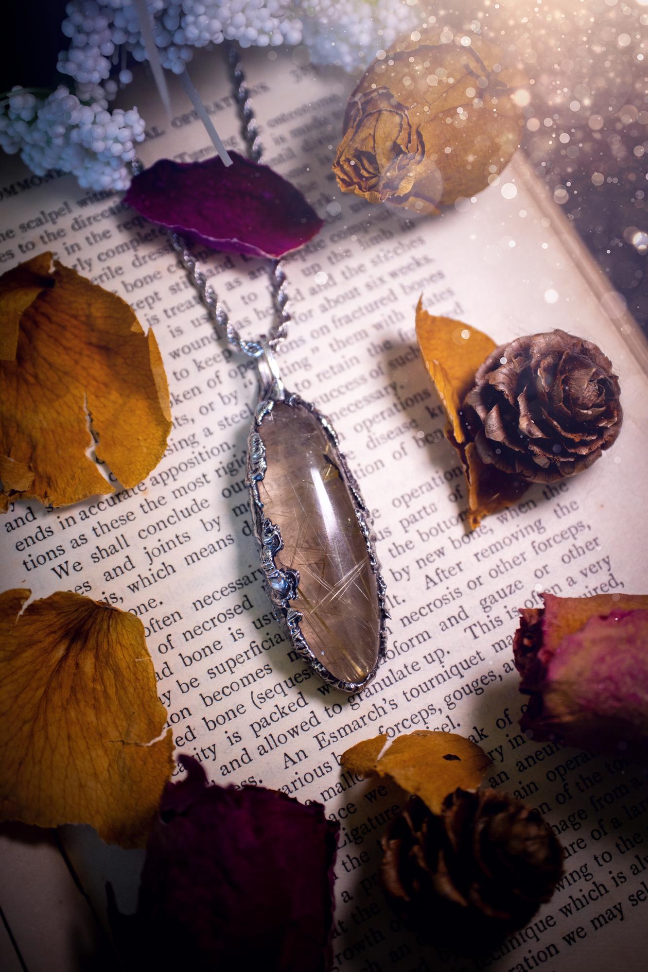 Handcrafted and unique, golden rutile quartz crystal, soft soldered pendant necklace. This pendant necklace has been handcrafted using the soft soldering method, also known as the tiffany technique. This method uses lead free solder which contains elements of silver for a high polish. This pendant features the most gorgeous and high quality, gold rutile quartz full of golden stripes with high clarity. Ideal gift for crystal and jewellery lovers. Witchy and gothic jewellery gifts for her.