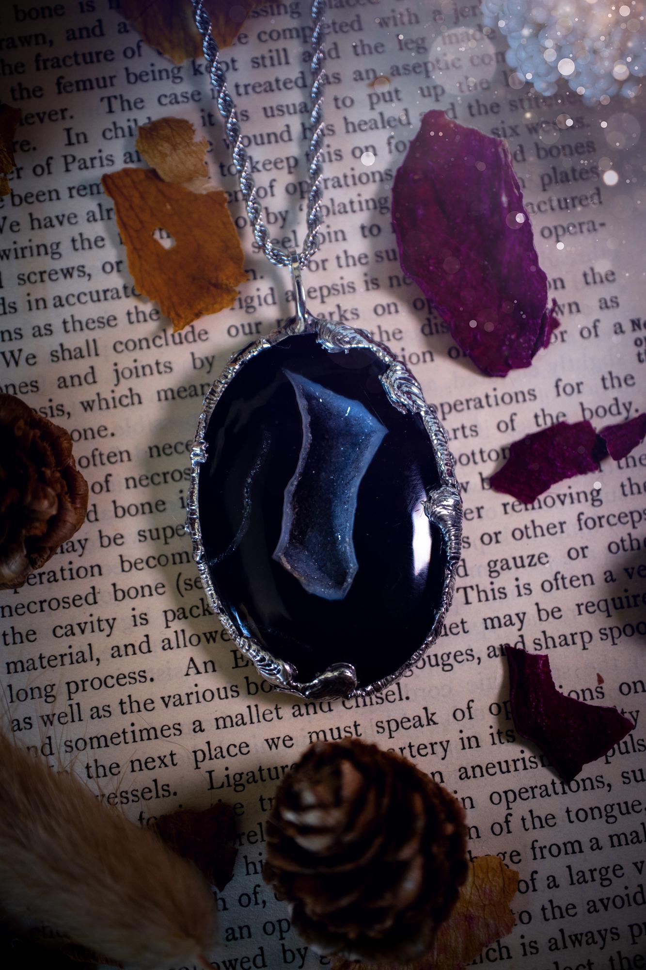 Beautiful and handcrafted, black druzy agate, crystal pendant necklace. This one of a kind piece of jewellery has been hand made using the tiffany technique, also known as soft soldering. The bezel is made with a solder that is lead free and contains elements of silver so when polished a high lustre is achieved. Featuring a large druzy agate with beautiful sparkle and banding. This is the ideal gift for any crystal or jewellery lover that likes a gothic and witchy vibe and aesthetic.