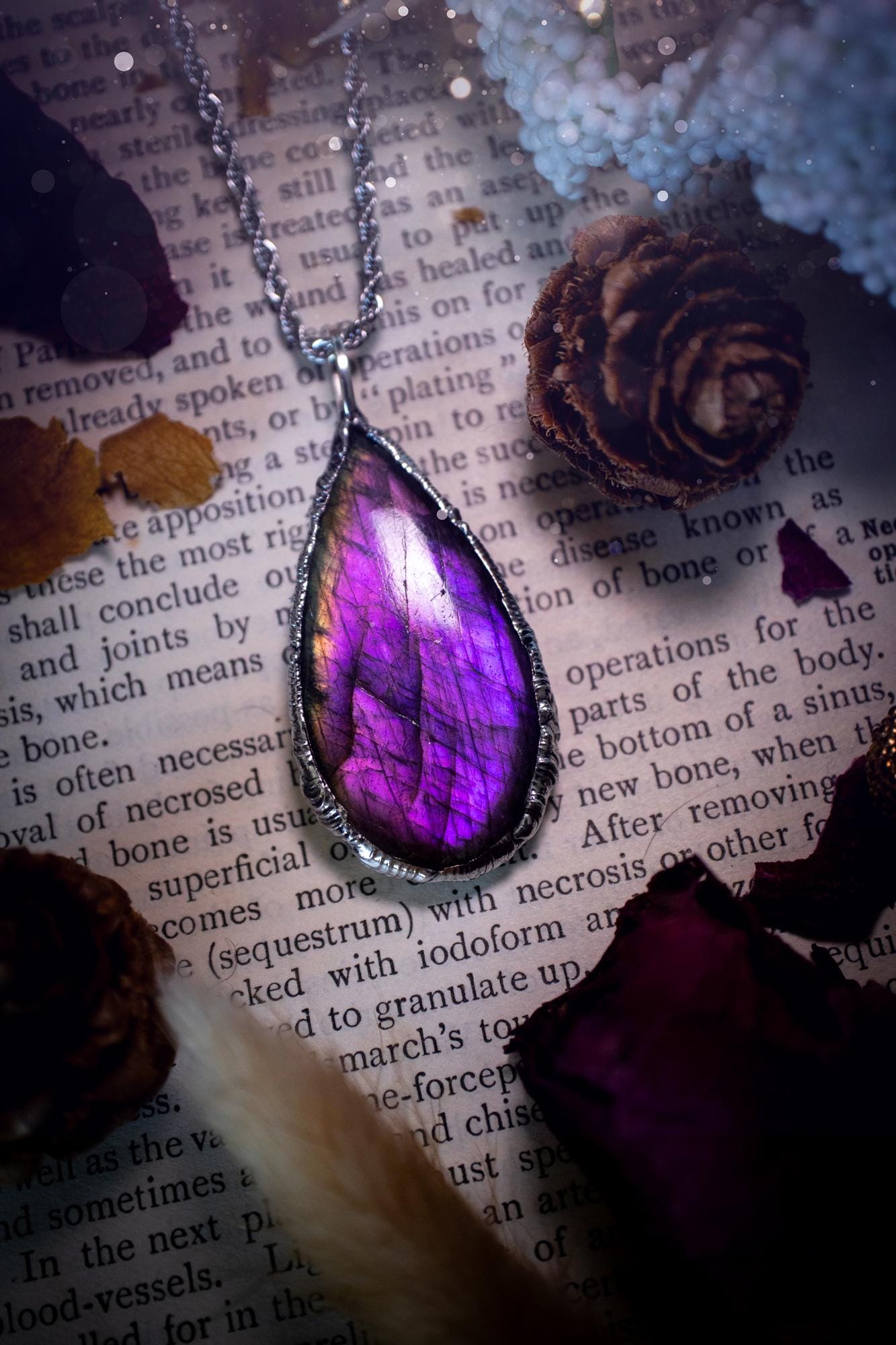 A beautiful, one of a kind, purple, green and grey multi-flash Labradorite crystal pendant necklace. This pendant has been handmade using the soft solder method, also known as the tiffany technique used to create stained glass windows. Featuring the most stunning and natural Labradorite crystal which is full of purple and green hues. The pendant is suitable for gifting to any jewellery or crystal lover, or to simply add to your own collection. One of a kind jewellery, gothic and witchy gifts