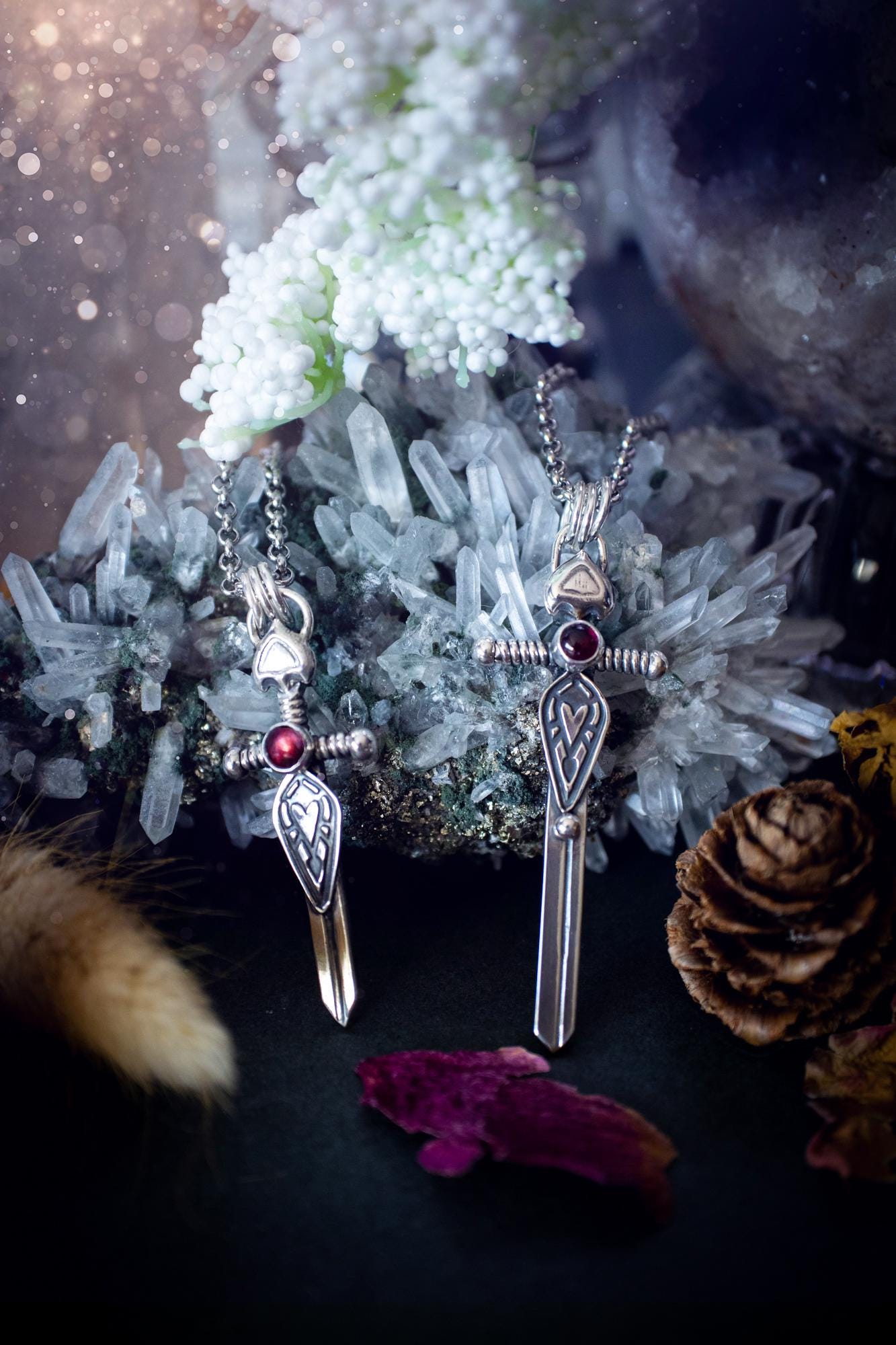 Handmade sterling silver pendant necklace in the shape of a sword, featuring a beautiful garnet as the centre piece. This piece of jewellery has been created using recycled fine and sterling silver and features a gorgeous garnet that is full of sparkle. Suitable or special occasions such as birthdays, anniversaries, graduations and more. Garnet is the birthstone for January. Witchy and gothic handmade jewellery, medieval.