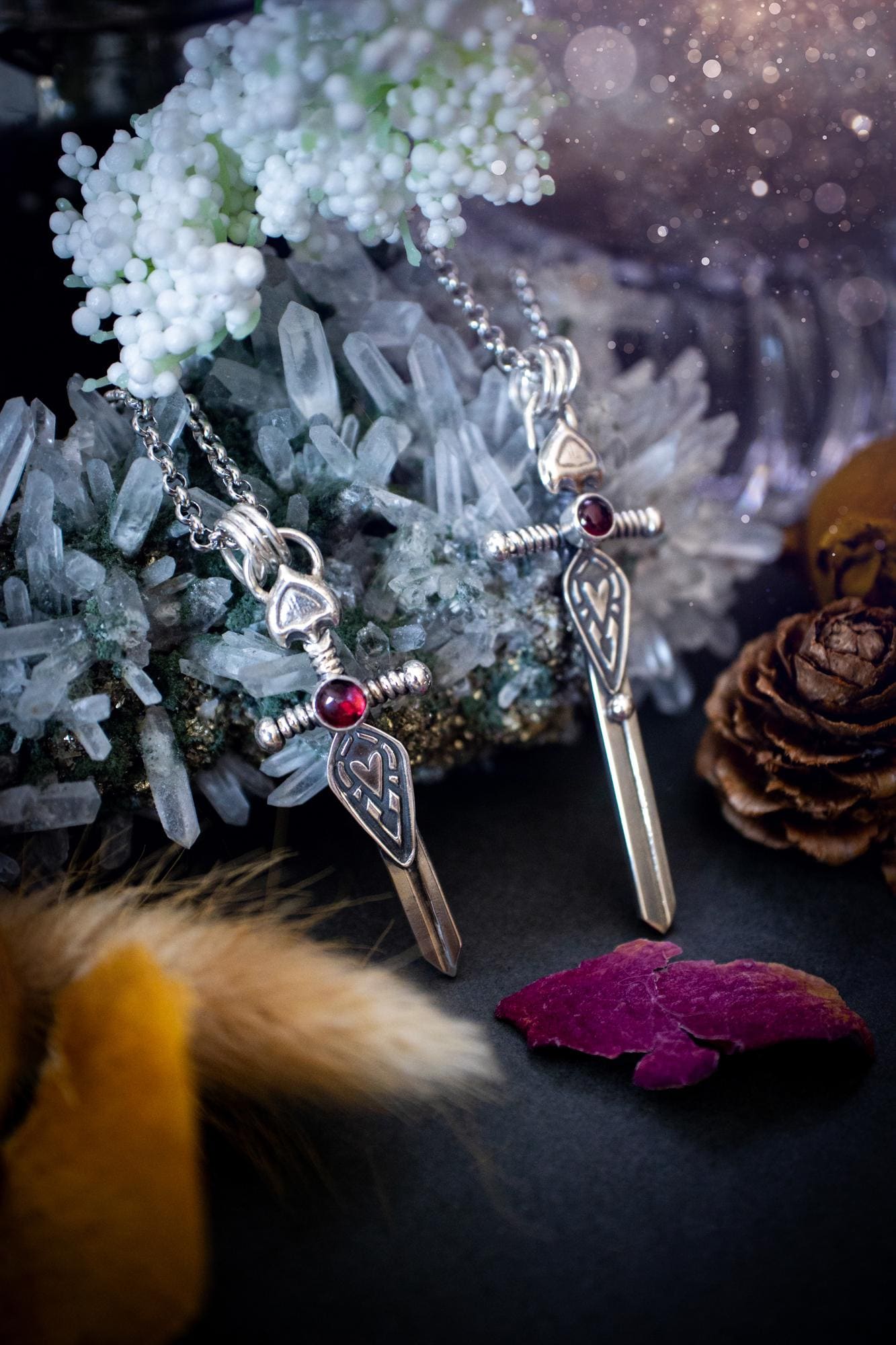 Handmade sterling silver pendant necklace in the shape of a sword, featuring a beautiful garnet as the centre piece. This piece of jewellery has been created using recycled fine and sterling silver and features a gorgeous garnet that is full of sparkle. Suitable or special occasions such as birthdays, anniversaries, graduations and more. Garnet is the birthstone for January. Witchy and gothic handmade jewellery, medieval.