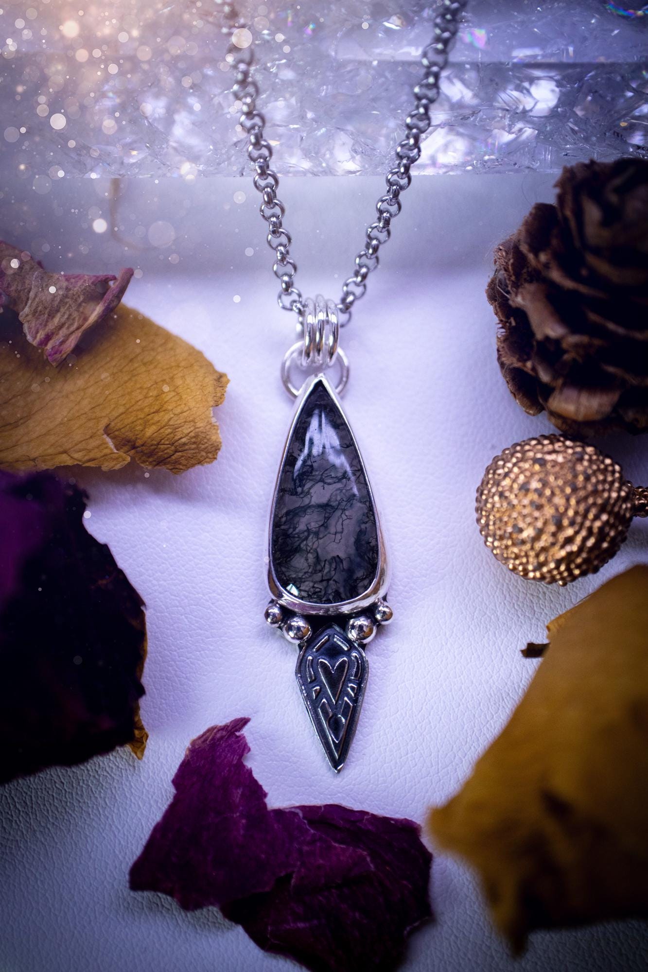 Handmade and one of a kind, 'heart of the wild' Moss agate crystal pendant necklace. This pendant necklace has been design and handmade from scratch, made from recycled fine and sterling silver. Featuring the moss beautiful and natural Moss agate crystal, with an open back on the pendant so you can see through the stone revealing all the beautiful mossy patterns. On the pendant is sterling silver ball components with a heart of the wild stamp, ideal gift for her, witchy and gothic jewell