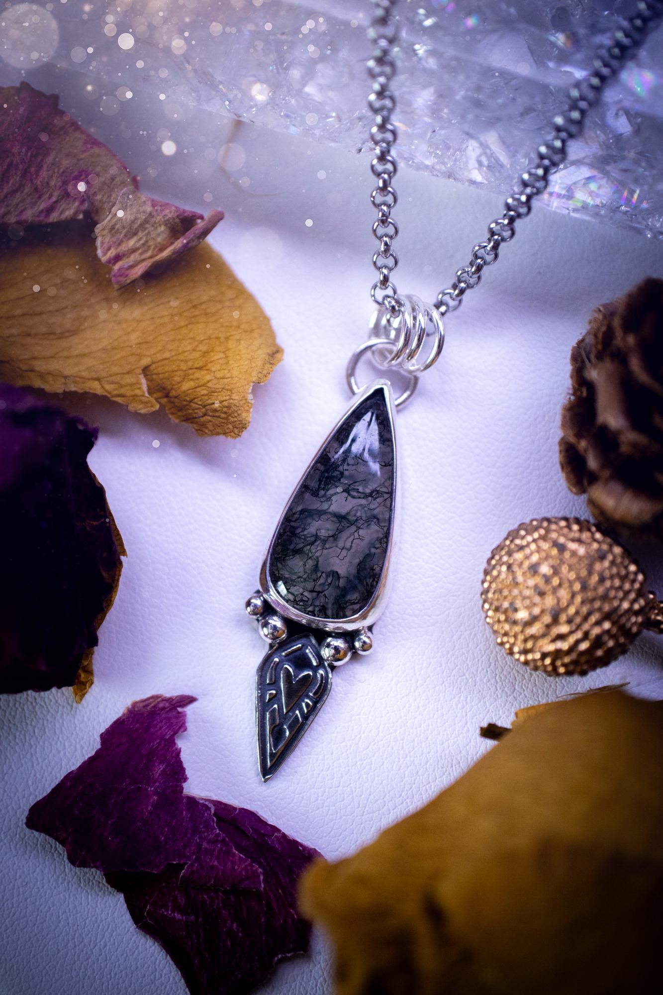Handmade and one of a kind, 'heart of the wild' Moss agate crystal pendant necklace. This pendant necklace has been design and handmade from scratch, made from recycled fine and sterling silver. Featuring the moss beautiful and natural Moss agate crystal, with an open back on the pendant so you can see through the stone revealing all the beautiful mossy patterns. On the pendant is sterling silver ball components with a heart of the wild stamp, ideal gift for her, witchy and gothic jewell
