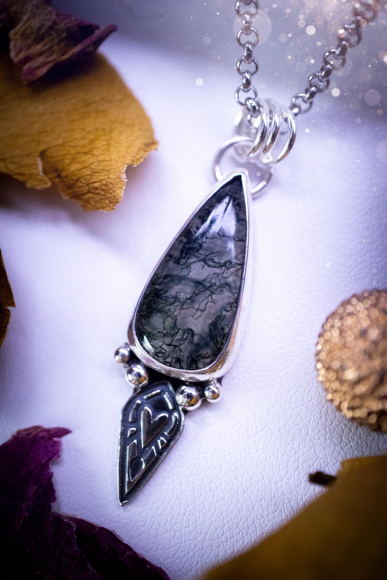 Handmade and one of a kind, 'heart of the wild' Moss agate crystal pendant necklace. This pendant necklace has been design and handmade from scratch, made from recycled fine and sterling silver. Featuring the moss beautiful and natural Moss agate crystal, with an open back on the pendant so you can see through the stone revealing all the beautiful mossy patterns. On the pendant is sterling silver ball components with a heart of the wild stamp, ideal gift for her, witchy and gothic jewell