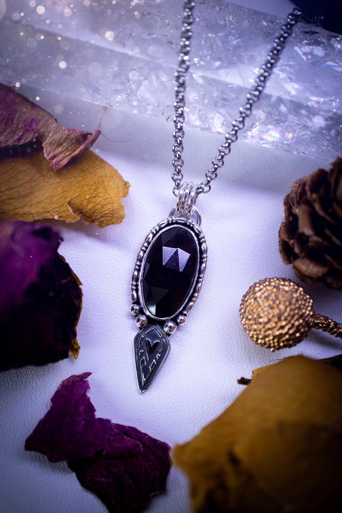 Handmade and one of a kind, 'heart of the wild' garnet crystal pendant necklace. This pendant necklace has been design and handmade from scratch, made from recycled fine and sterling silver. Featuring the most beautiful and natural garnet crystal, the crystal is a deep dark red with pink hues, but can look nearly black from some angles. On the pendant is sterling silver ball components with a heart of the wild stamp, ideal gift for her, witchy and gothic jewellery.