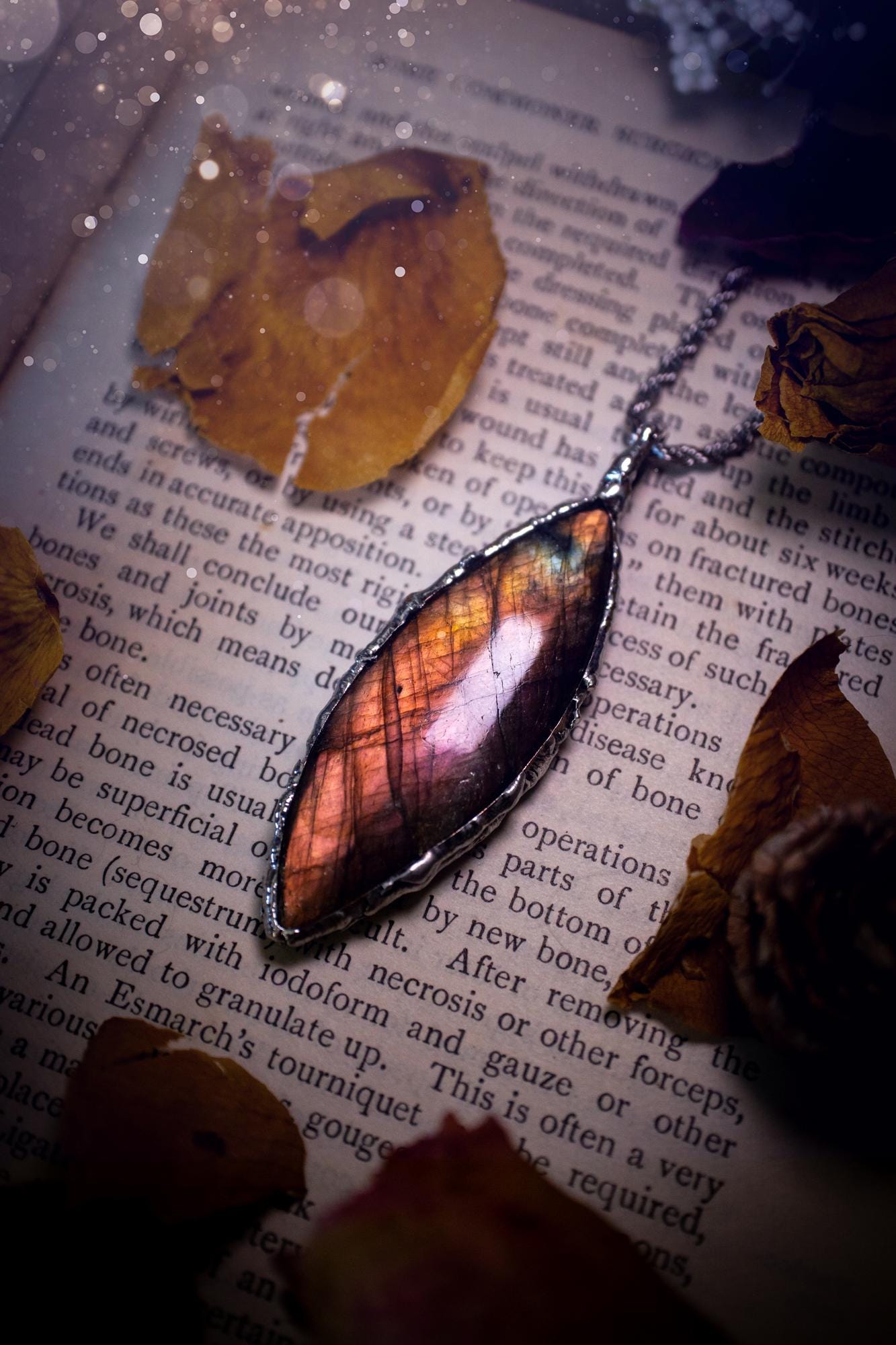 A beautiful, one of a kind, pink, purple and orange multi-flash Labradorite crystal pendant necklace. This pendant has been handmade using the soft solder method, also known as the tiffany technique used to create stained glass windows. Featuring the most stunning and natural Labradorite crystal which is full of purple and pink hues. The pendant is suitable for gifting to any jewellery or crystal lover, or to simply add to your own collection. One of a kind jewellery, gothic and witchy gifts