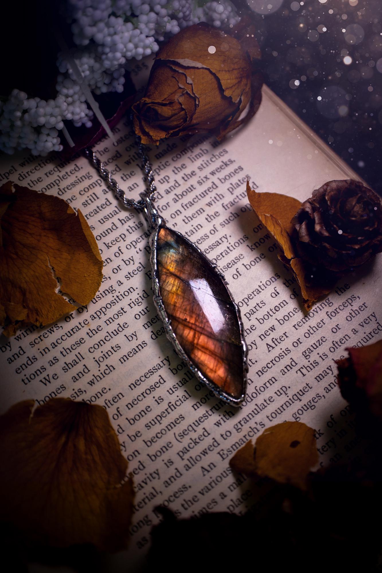 A beautiful, one of a kind, pink, purple and orange multi-flash Labradorite crystal pendant necklace. This pendant has been handmade using the soft solder method, also known as the tiffany technique used to create stained glass windows. Featuring the most stunning and natural Labradorite crystal which is full of purple and pink hues. The pendant is suitable for gifting to any jewellery or crystal lover, or to simply add to your own collection. One of a kind jewellery, gothic and witchy gifts