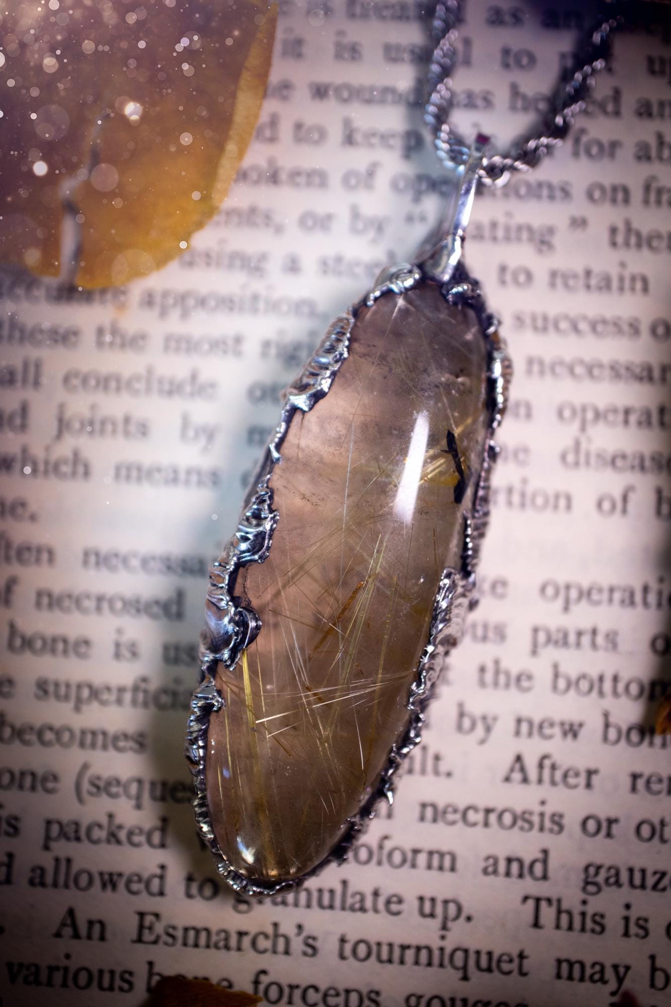 Handcrafted and unique, golden rutile quartz crystal, soft soldered pendant necklace. This pendant necklace has been handcrafted using the soft soldering method, also known as the tiffany technique. This method uses lead free solder which contains elements of silver for a high polish. This pendant features the most gorgeous and high quality, gold rutile quartz full of golden stripes with high clarity. Ideal gift for crystal and jewellery lovers. Witchy and gothic jewellery gifts for her.