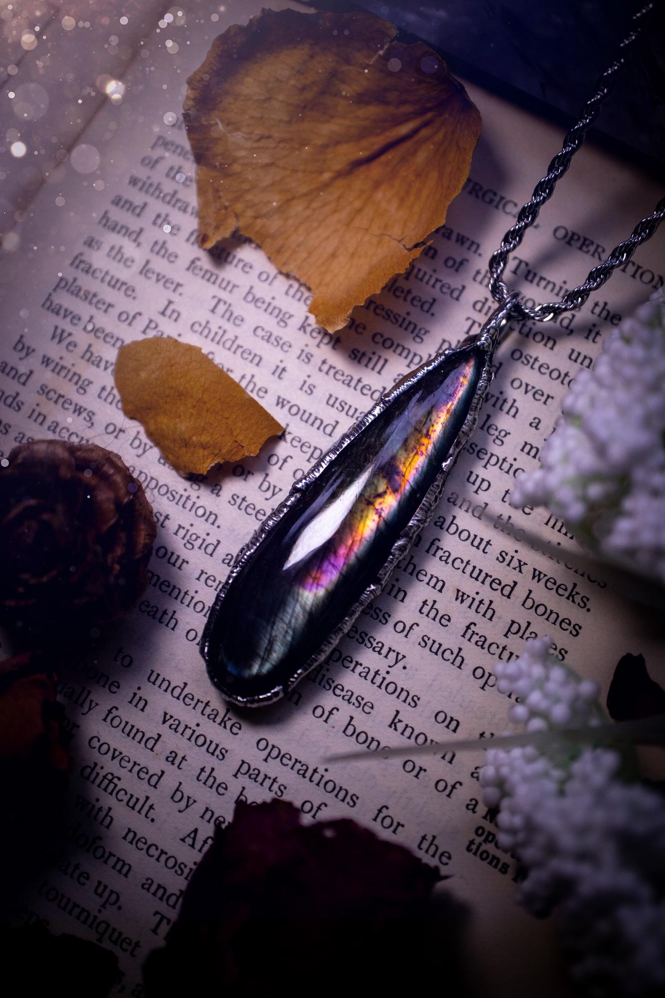 A beautiful, one of a kind, purple, green and grey multi-flash Labradorite crystal pendant necklace. This pendant has been handmade using the soft solder method, also known as the tiffany technique used to create stained glass windows. Featuring the most stunning and natural Labradorite crystal which is full of purple and green hues. The pendant is suitable for gifting to any jewellery or crystal lover, or to simply add to your own collection. One of a kind jewellery, gothic and witchy gifts