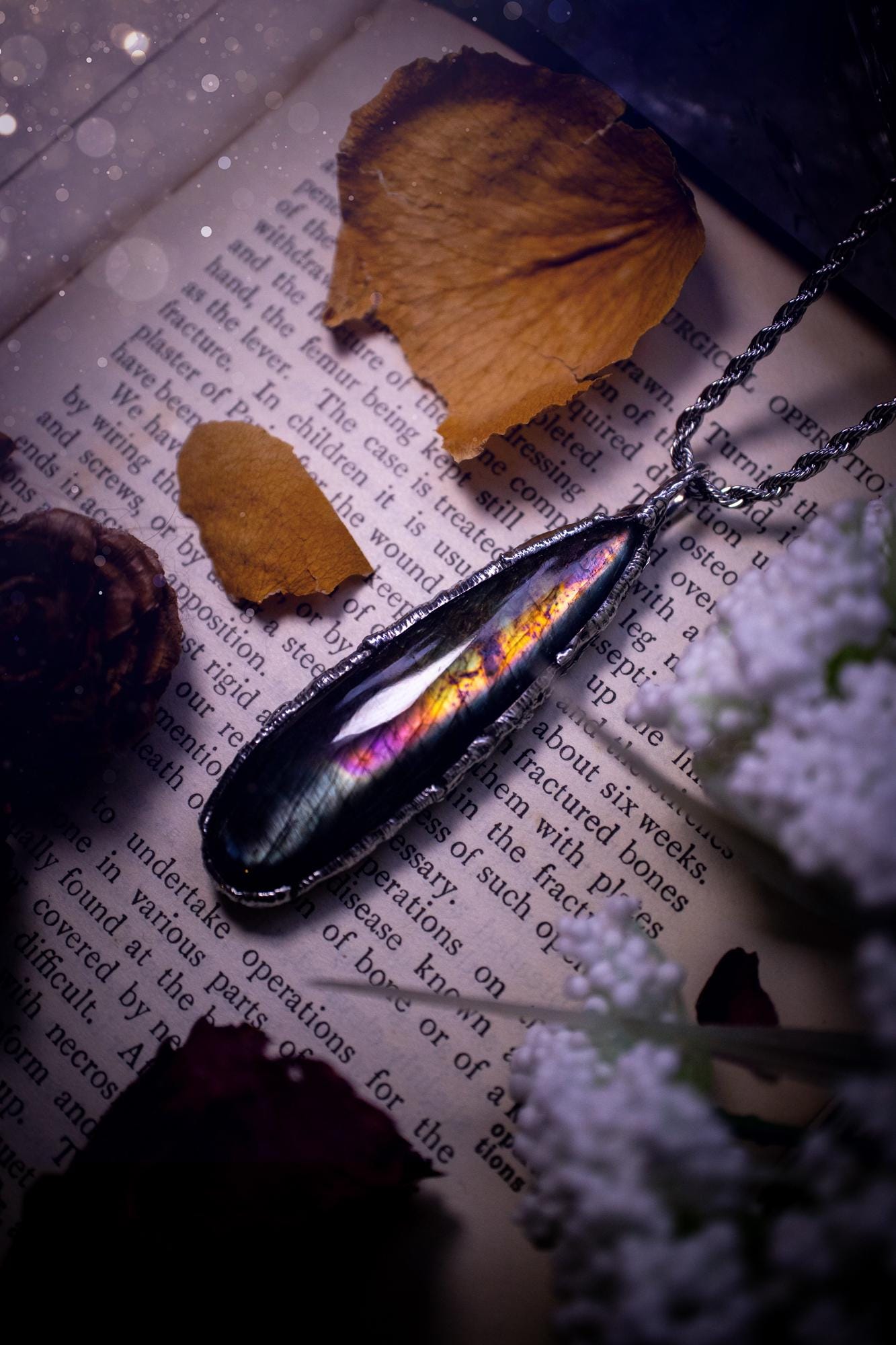 A beautiful, one of a kind, purple, green and grey multi-flash Labradorite crystal pendant necklace. This pendant has been handmade using the soft solder method, also known as the tiffany technique used to create stained glass windows. Featuring the most stunning and natural Labradorite crystal which is full of purple and green hues. The pendant is suitable for gifting to any jewellery or crystal lover, or to simply add to your own collection. One of a kind jewellery, gothic and witchy gifts