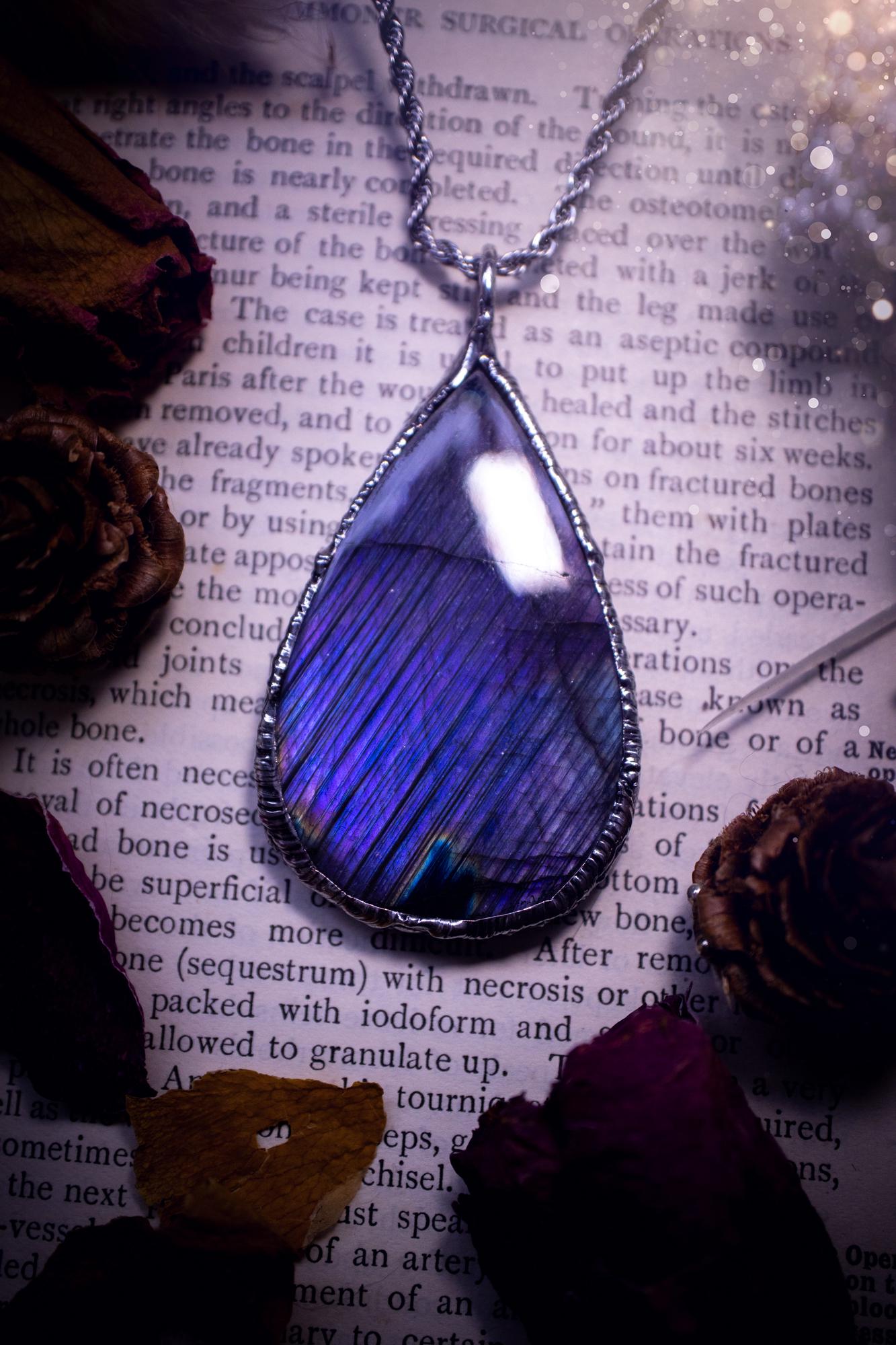 The ultimate labradorite soft soldered pendant necklace. This pendant necklace features the most beautiful and natural Labradorite spectrolite crystal that has so many hues of blue and purple, with stripes. Handmade using the tiffany technique, also known as soft soldering. This piece is made from solder which contains metals and silver and is safe to wear. The ideal gift for any jewellery lover and crystal collector! Witchy, gothic and hippy jewellery that has been made for the soul.