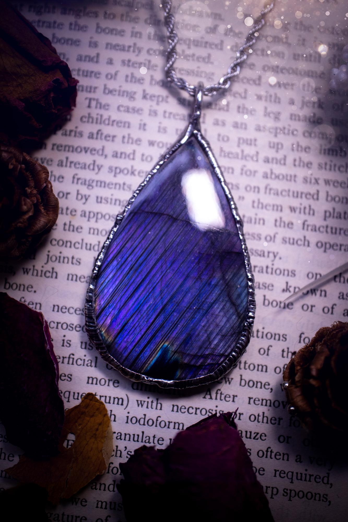 The ultimate labradorite soft soldered pendant necklace. This pendant necklace features the most beautiful and natural Labradorite spectrolite crystal that has so many hues of blue and purple, with stripes. Handmade using the tiffany technique, also known as soft soldering. This piece is made from solder which contains metals and silver and is safe to wear. The ideal gift for any jewellery lover and crystal collector! Witchy, gothic and hippy jewellery that has been made for the soul.