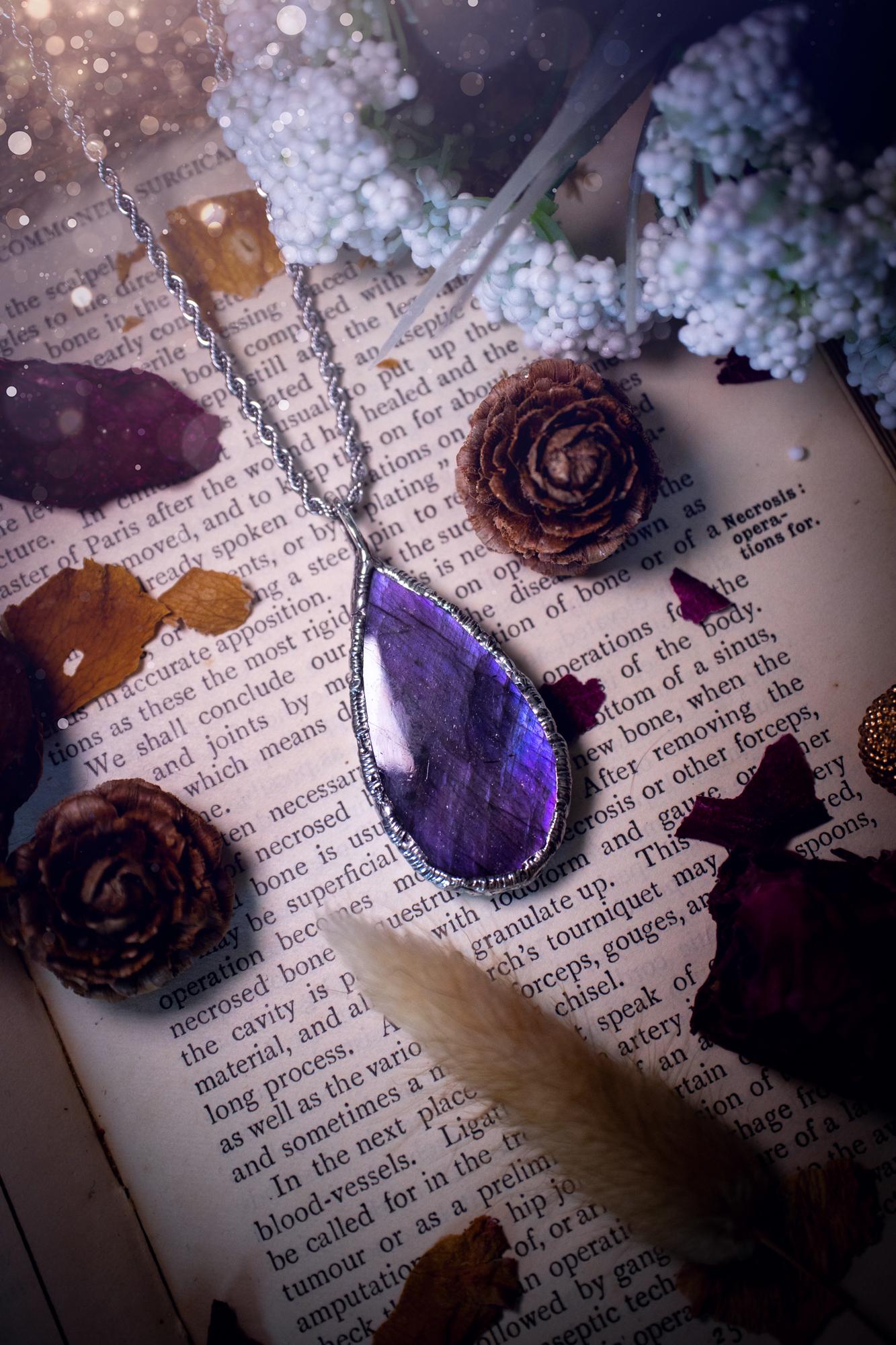 A beautiful, one of a kind, purple, green and grey multi-flash Labradorite crystal pendant necklace. This pendant has been handmade using the soft solder method, also known as the tiffany technique used to create stained glass windows. Featuring the most stunning and natural Labradorite crystal which is full of purple and green hues. The pendant is suitable for gifting to any jewellery or crystal lover, or to simply add to your own collection. One of a kind jewellery, gothic and witchy gifts