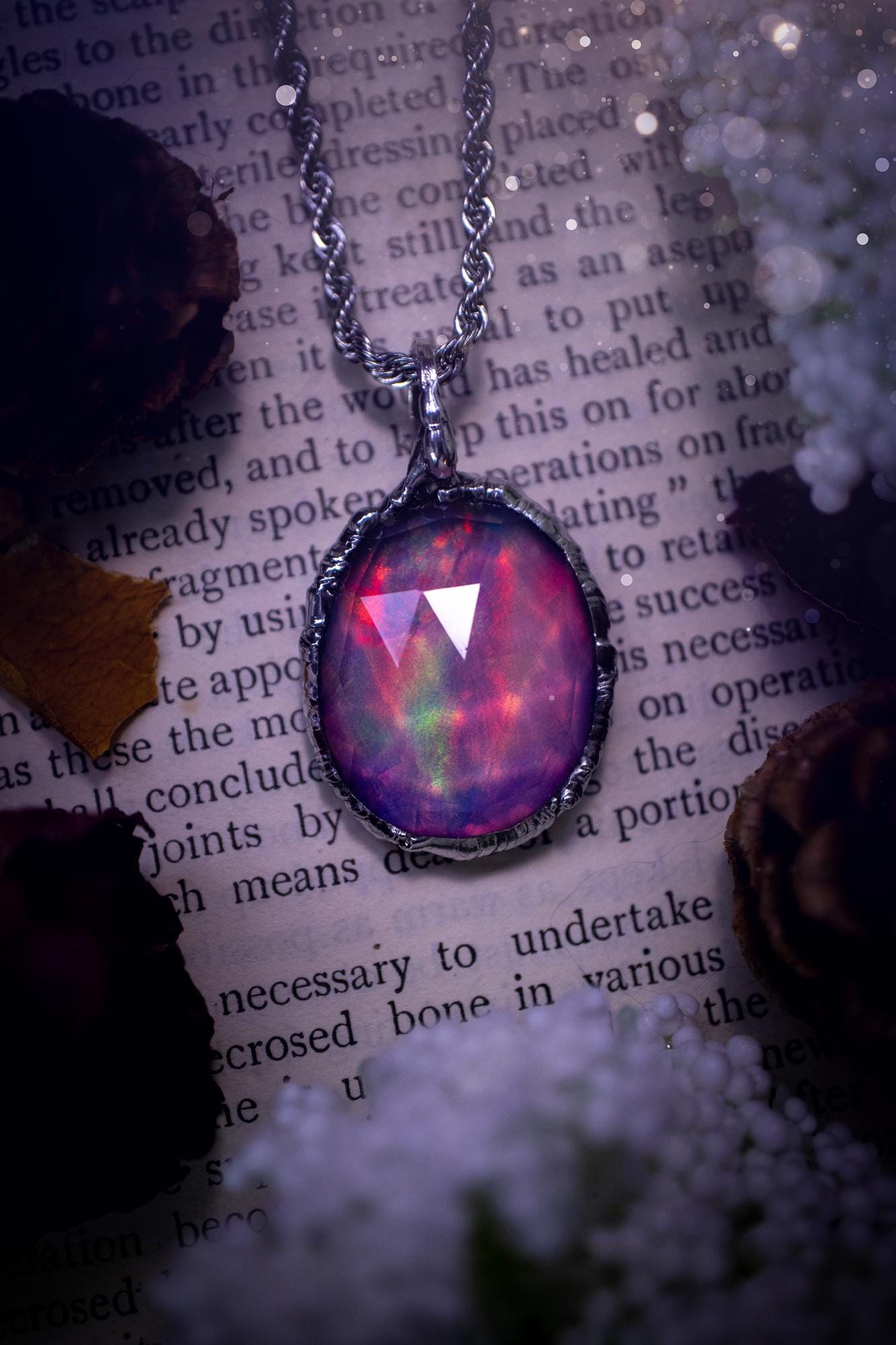 A beautiful, one of a kind, aurora opal pendant necklace. This little statement necklace is handmade using the tiffany technique, also known as soft soldering. Featuring the most stunning, and sparkly aurora opal which is full of pinks, greens and blues just like the northern lights. Aurora opals are man made opals that look similar to natural ones, they have a layer of rose quartz on top to give extra shine. The ideal gift for any crystal or jewellery lover. Gothic and witchy jewellery